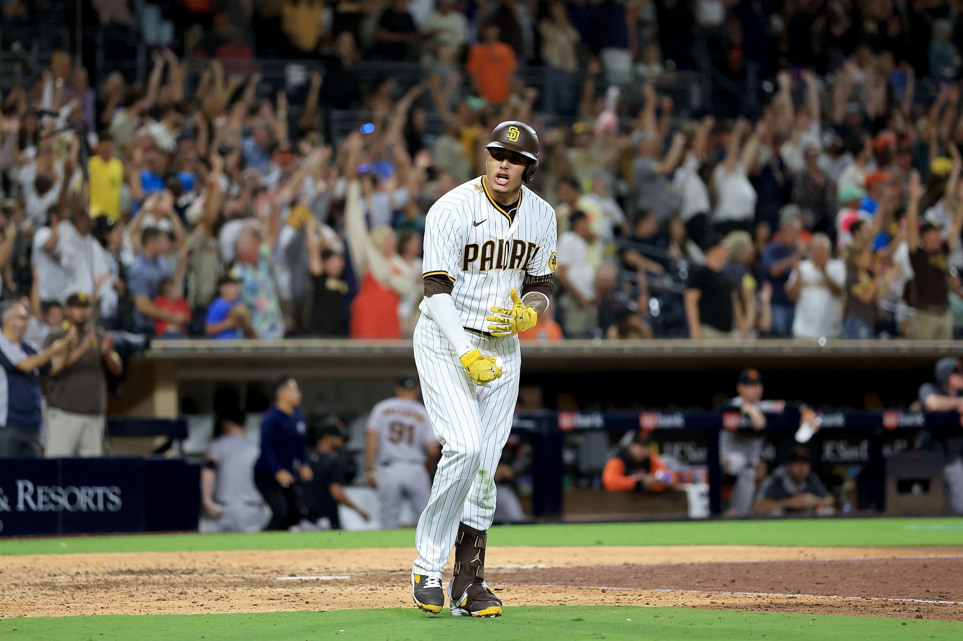 Machado #13 of the San Diego Padres reacts after hitting a three-run home run during the ninth inning of a game against the San Francisco Giants at PETCO Park on August 09, 2022, in San Diego, California.