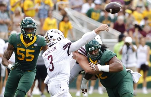 Siaki Ika #62 of the Baylor Bears and teammate Garmon Randolph #55 pressure Layne Hatcher #3 of the Texas State Bobcats