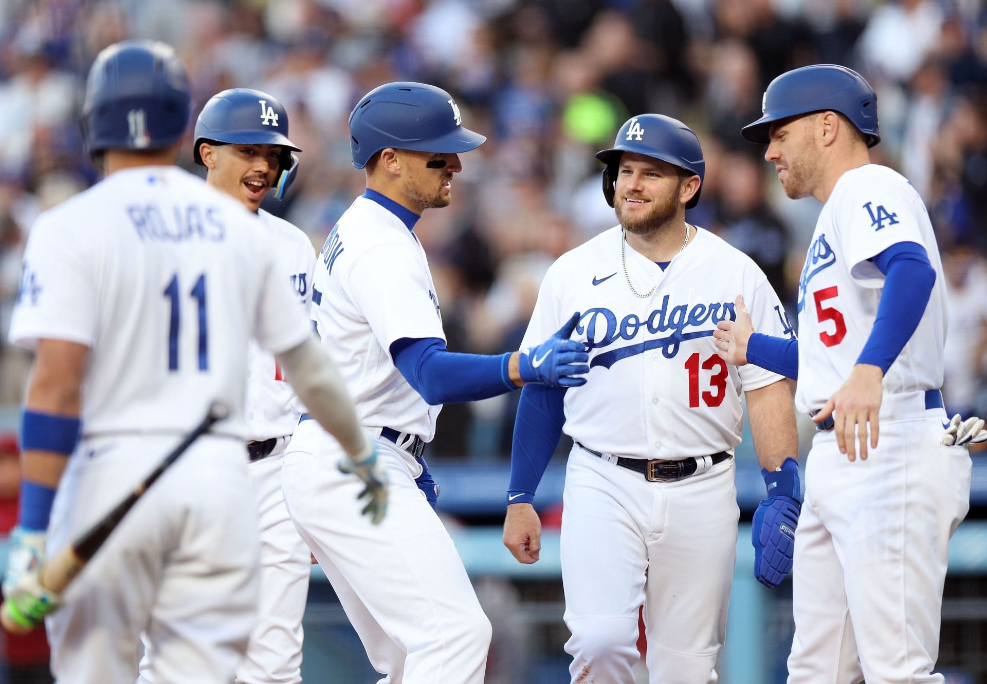 Trayce Thompson #25 of the Los Angeles Dodgers celebrates his grand slam homerun with Freddie Freeman #5, Max Muncy #13, Miguel Vargas #17, and Miguel Rojas #11, to take a 5-0 lead over the Arizona Diamondbacks, during the first inning at Dodger Stadium on April 01, 2023, in Los Angeles, California.