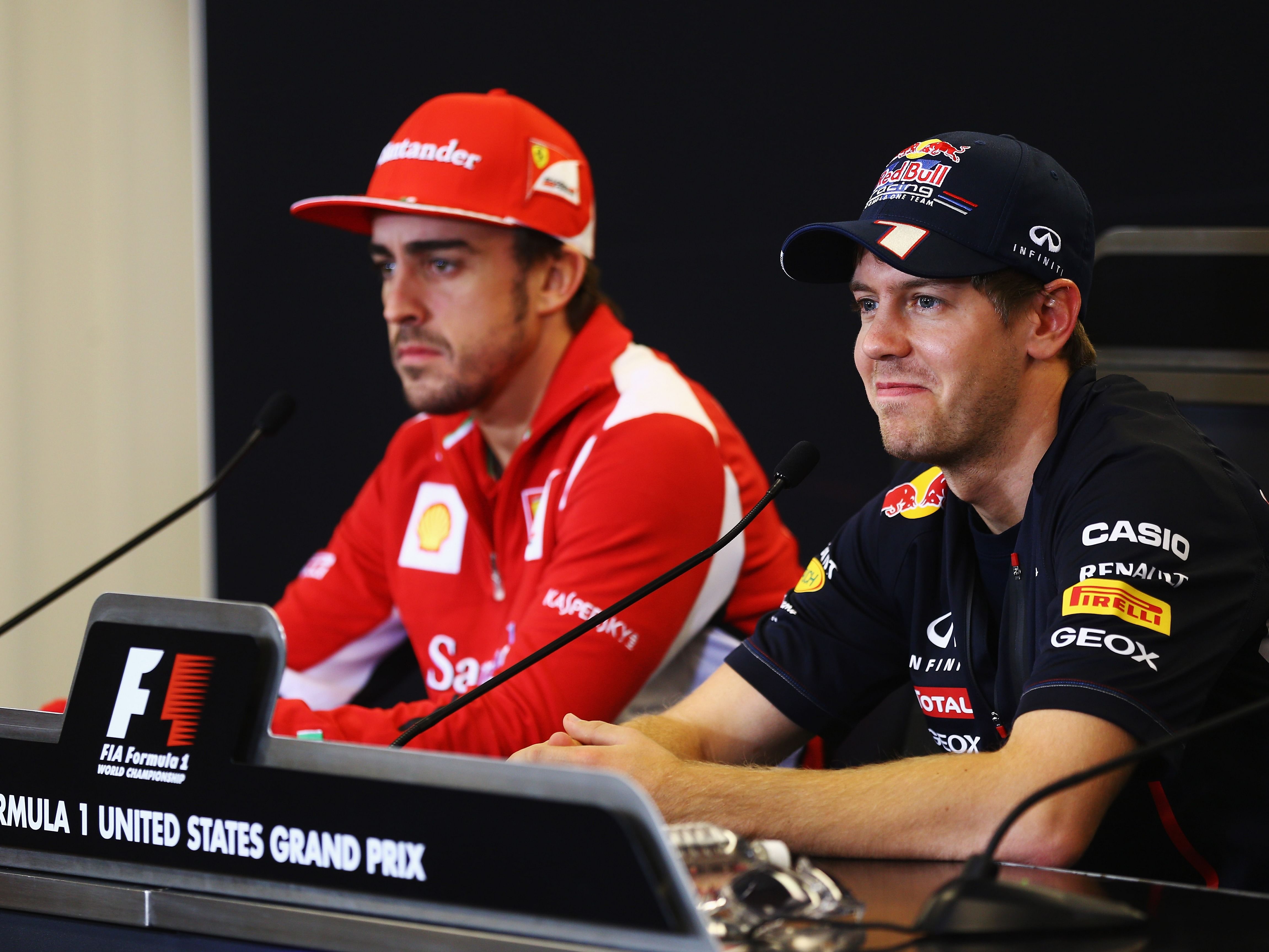 Sebastian Vettel (R) and Fernando Alonso (L) attend the drivers press conference during previews to the 2012 F1 United States Grand Prix. (Photo by Paul Gilham/Getty Images)