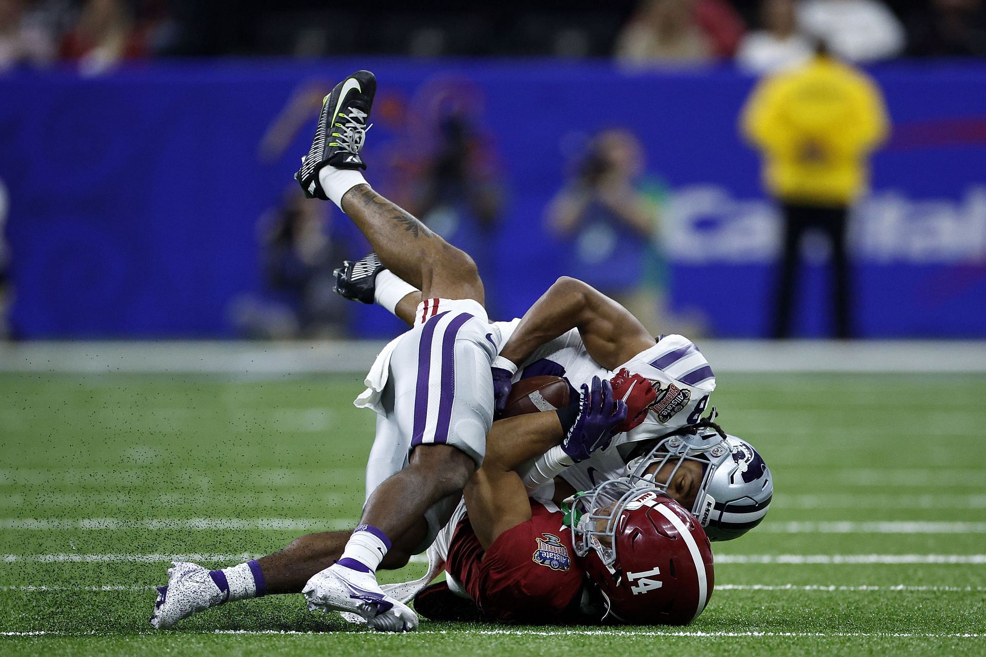 Phillip Brooks #8 of the Kansas State Wildcats is tackled by Brian Branch