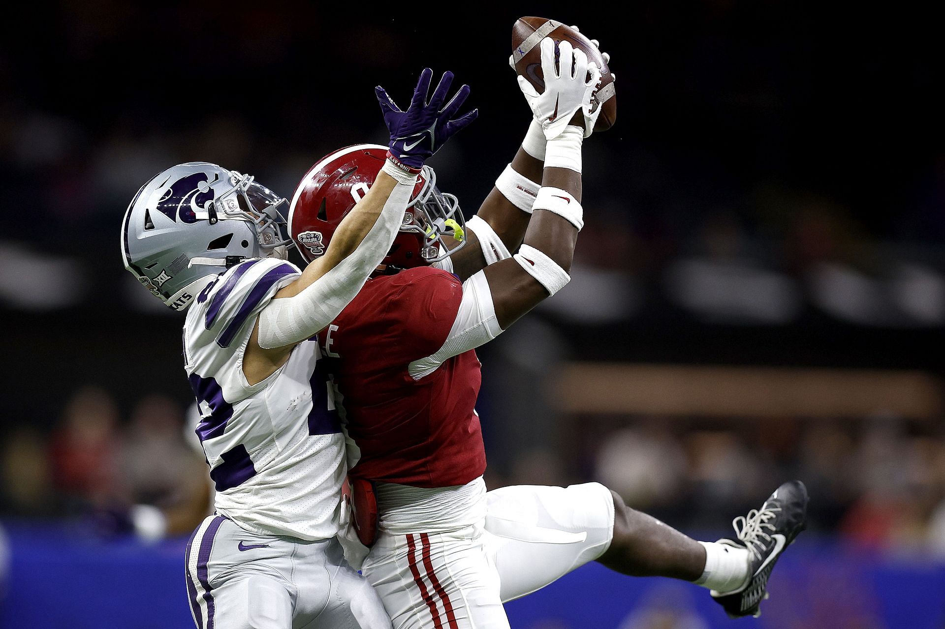 Jordan Battle #9 of the Alabama Crimson Tide intercepts a pass to Deuce Vaughn #22 of the Kansas State Wildcats