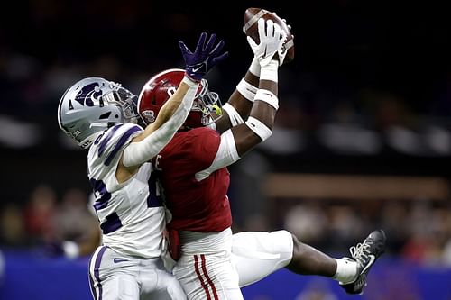 Jordan Battle #9 of the Alabama Crimson Tide intercepts a pass to Deuce Vaughn #22 of the Kansas State Wildcats