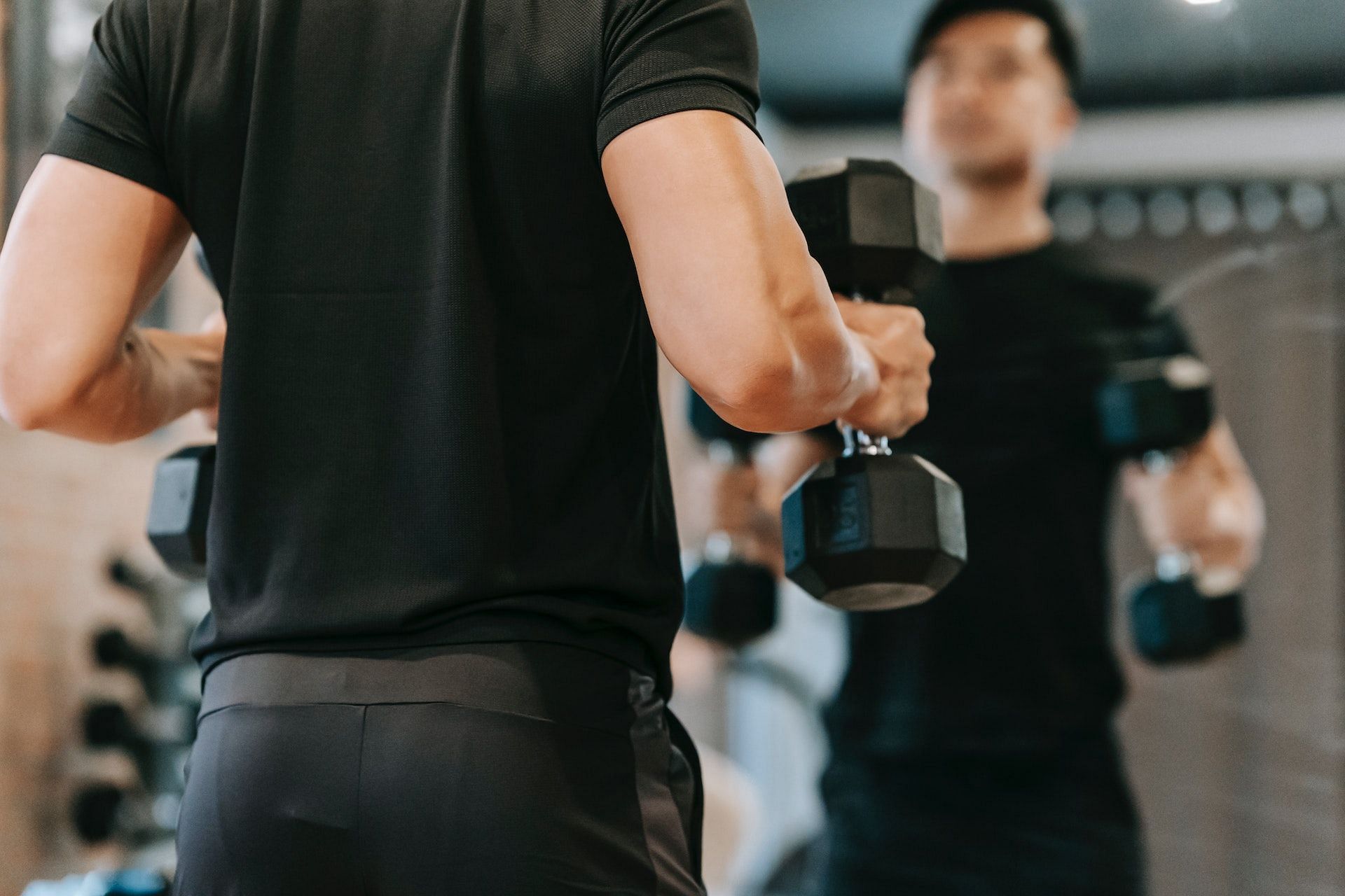 Dumbbell overhead press helps build shoulder size and strength. (Photo via Pexels/Andres Ayrton)