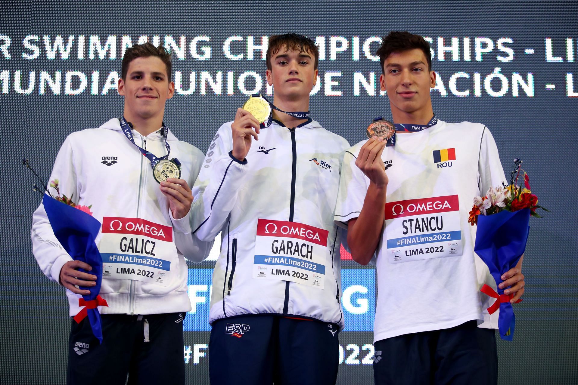 Silver medalist Laszio Galicz of Hungary, Gold medalist Carlos Garach of Spain and Bronze medalist Vlad Stancu of Romania celebrate on the podium after the Men's 1500m Freestyle on day six of FINA World Junior Swimming Championships Lima 2022