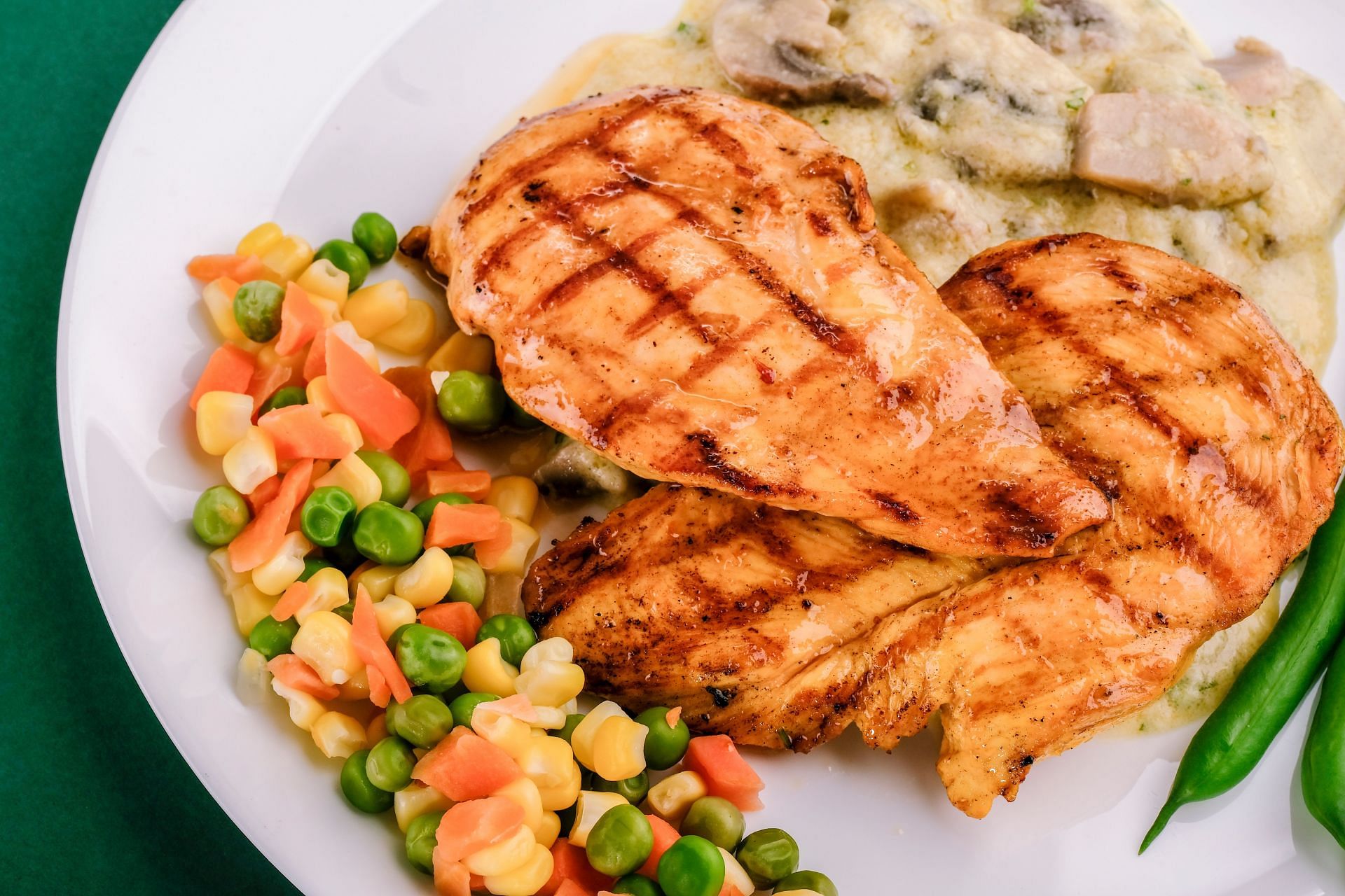 Grilled chicken breast is a great addition to a balanced diet. (Image via Unsplash/ Sam Khamseh)