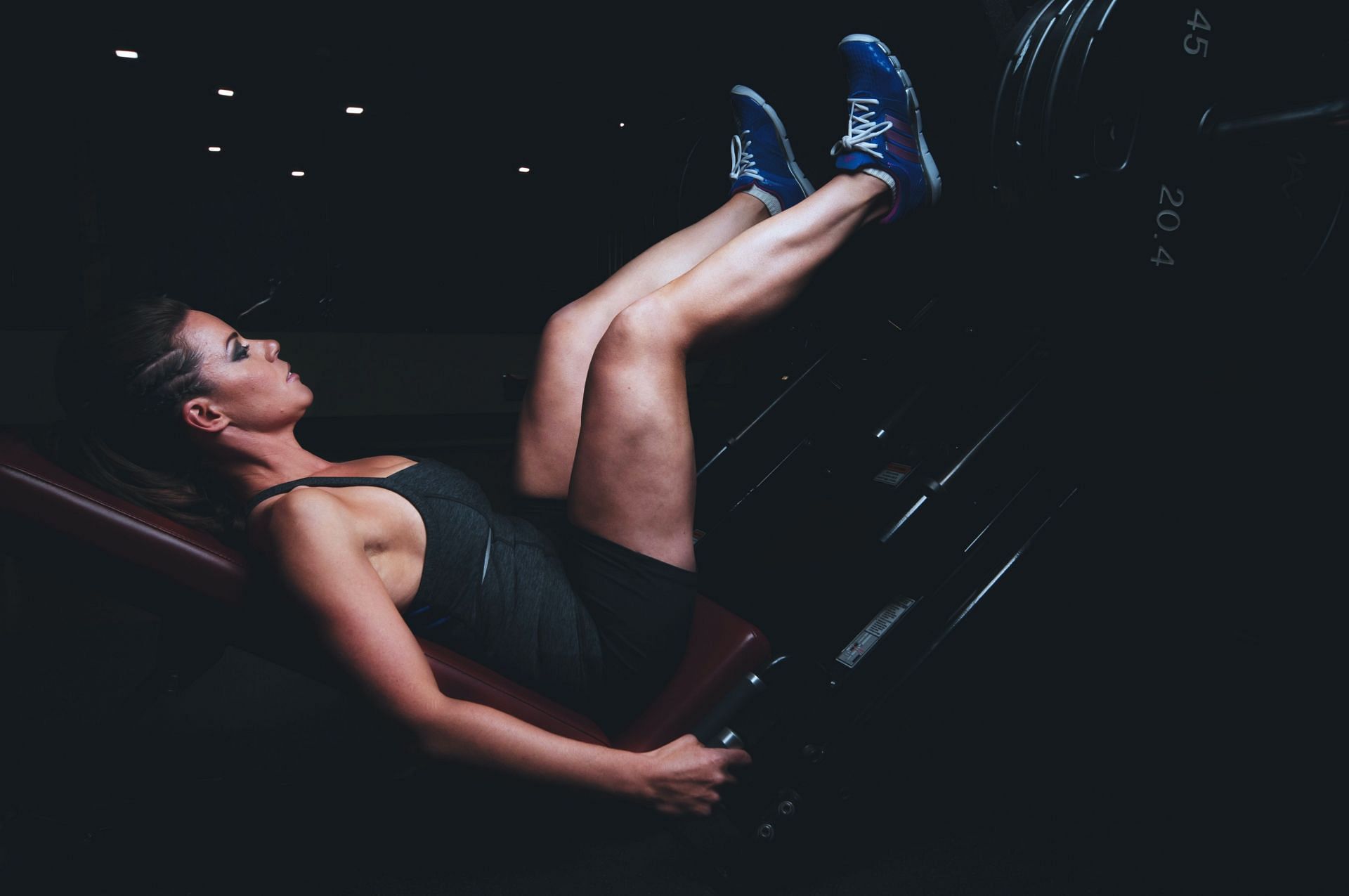 Pendulum squats are performed on the machine. (Image via Unsplash/ Scott Webb)