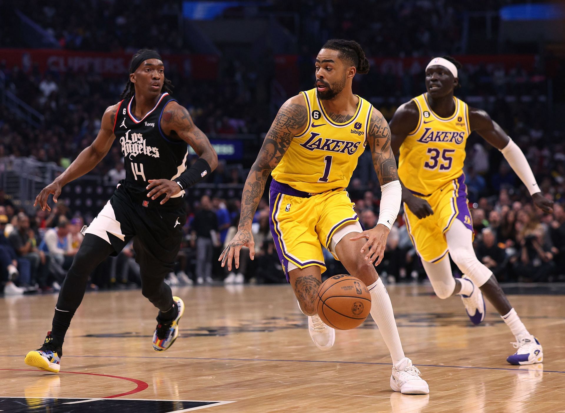 D&#039;Angelo Russell #1 of the Los Angeles Lakers dribbles away from Terance Mann #14 of the LA Clippers