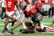 Emeka Egbuka #2 of the Ohio State Buckeyes is tackled by Chris Smith #29 of the Georgia Bulldogs