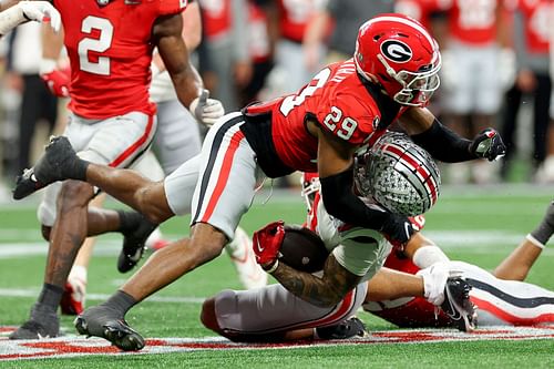 Emeka Egbuka #2 of the Ohio State Buckeyes is tackled by Chris Smith #29 of the Georgia Bulldogs 