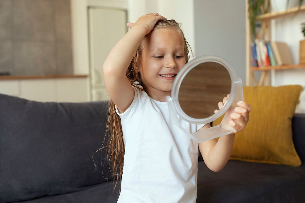 Nits are white eggs that attach to hair shafts near the scalp. (Image via Freepik)