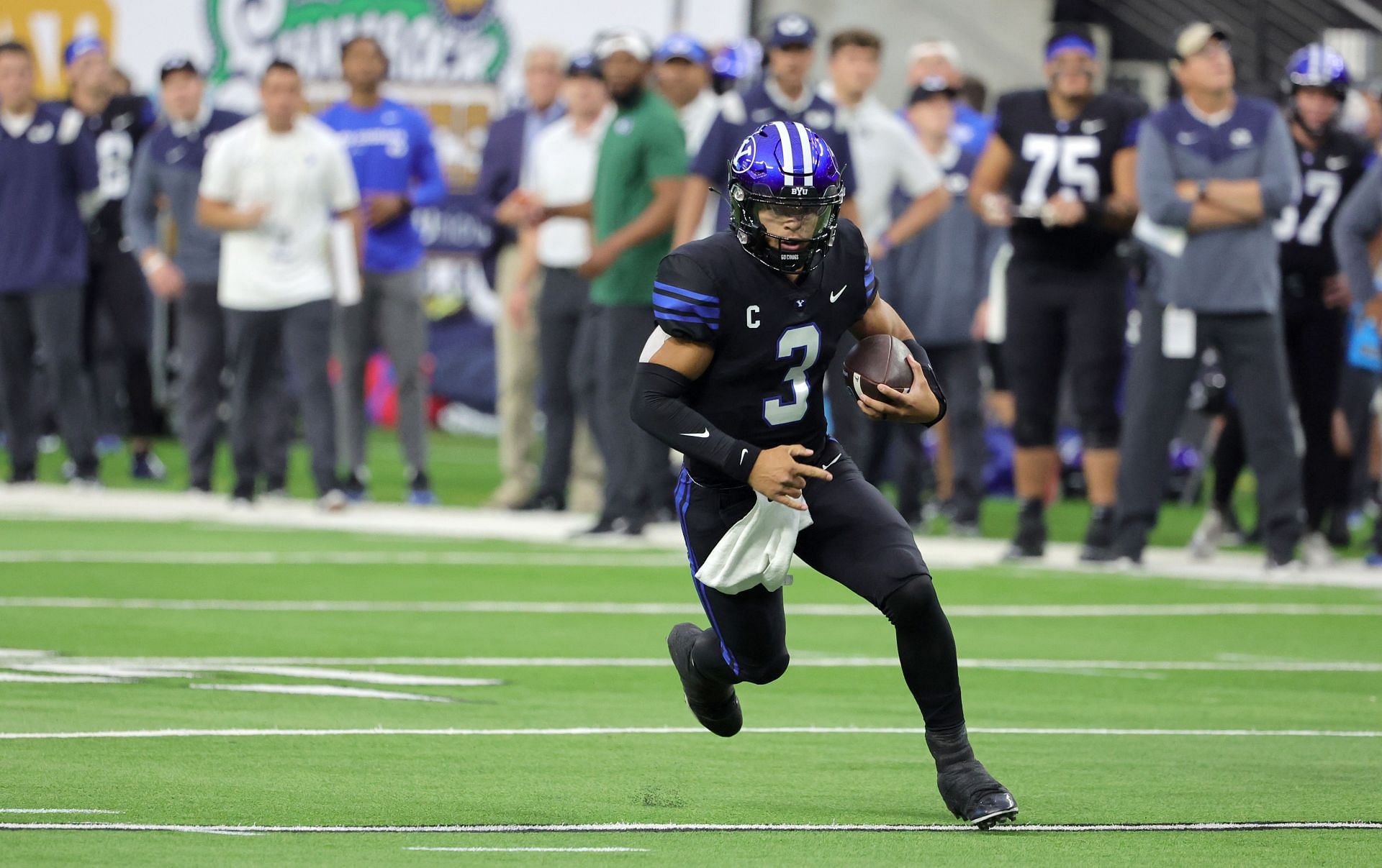 Jaren Hall #3 of the Brigham Young Cougars carries the ball against the Notre Dame Fighting Irish