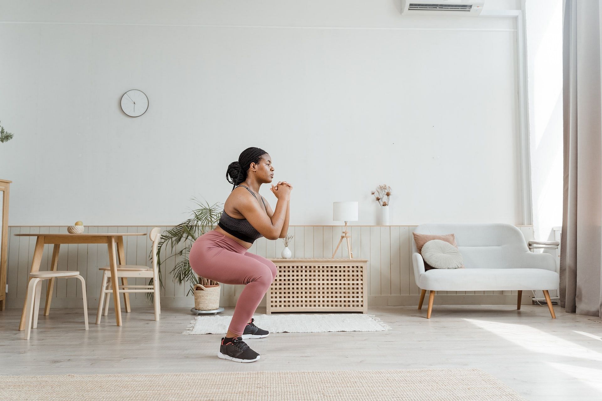 Squats stretch the lower body muscles. (Photo via Pexels/MART PRODUCTION)