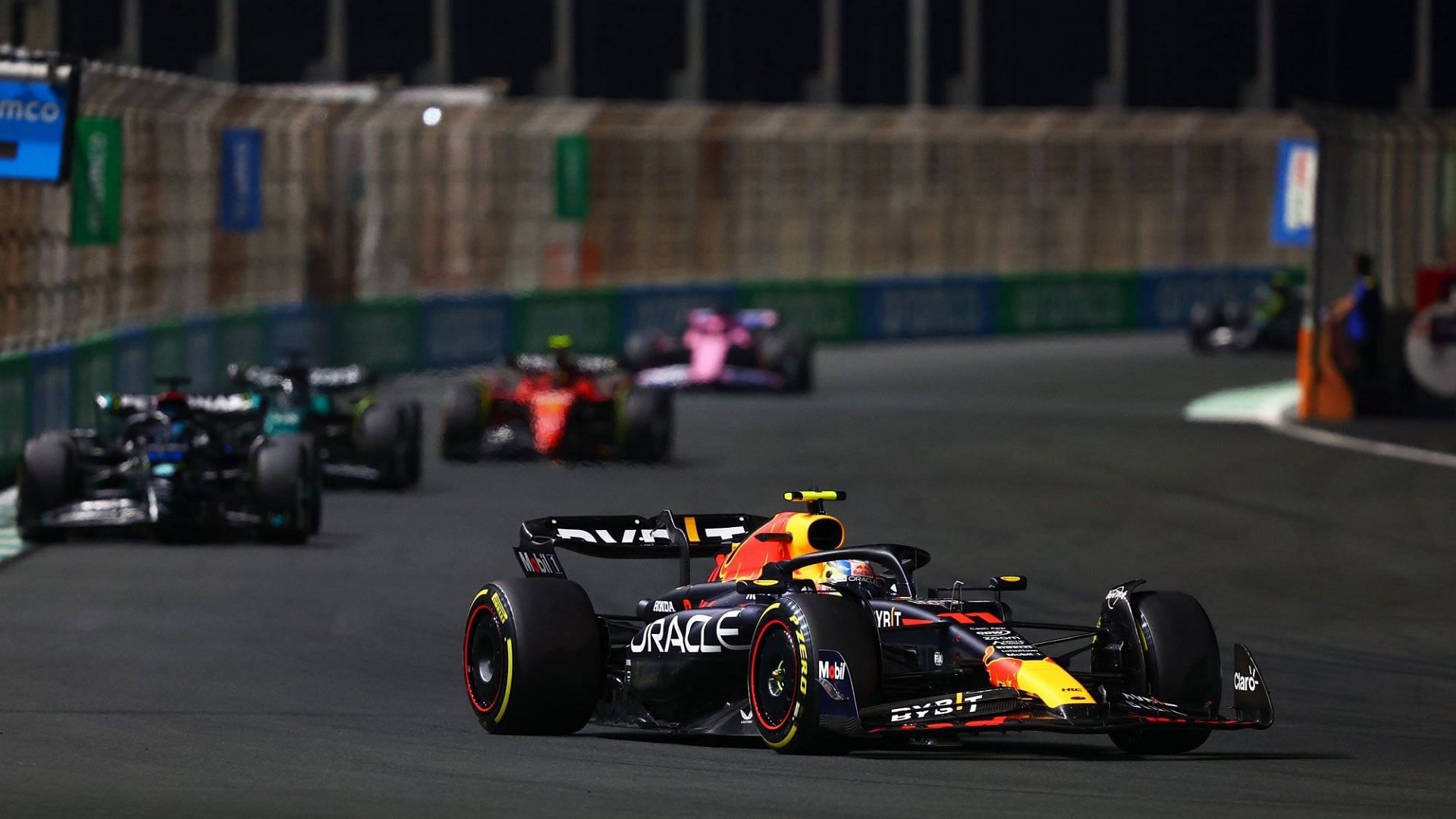 Cars of different constructors zoom past a corner at 2023 Saudi Arabian GP.