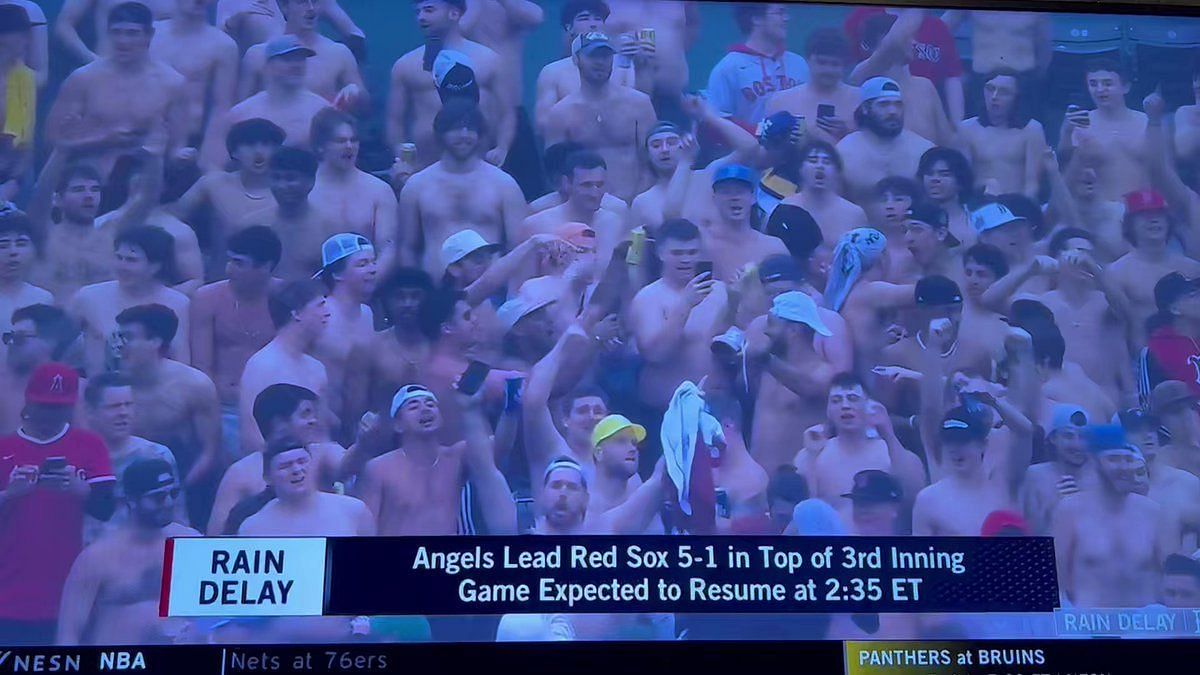 Red Sox fans go shirtless during lengthy rain delay at Fenway