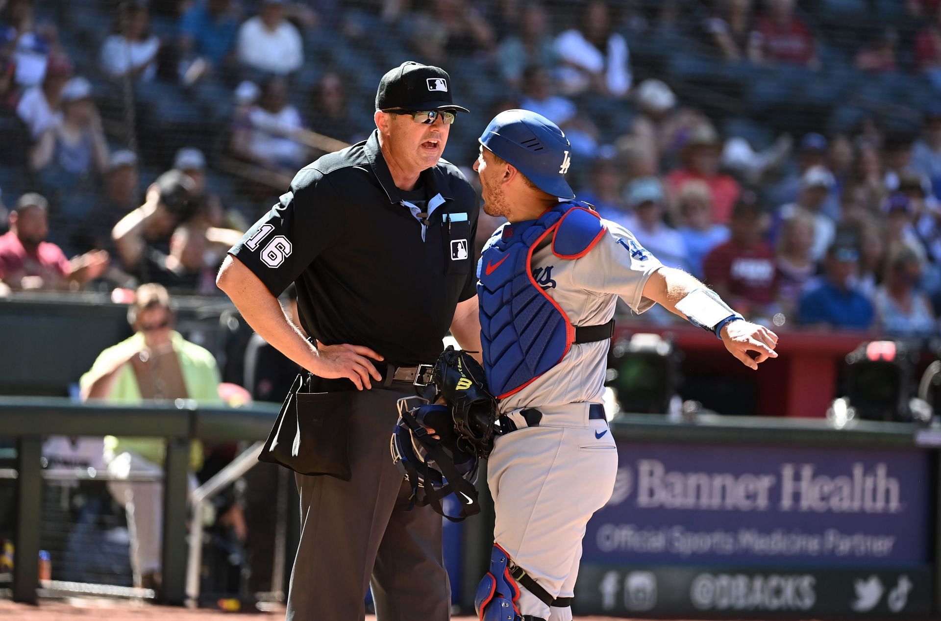 Austin Barnes #15 of the Los Angeles Dodgers argues with home plate umpire Lance Barrett