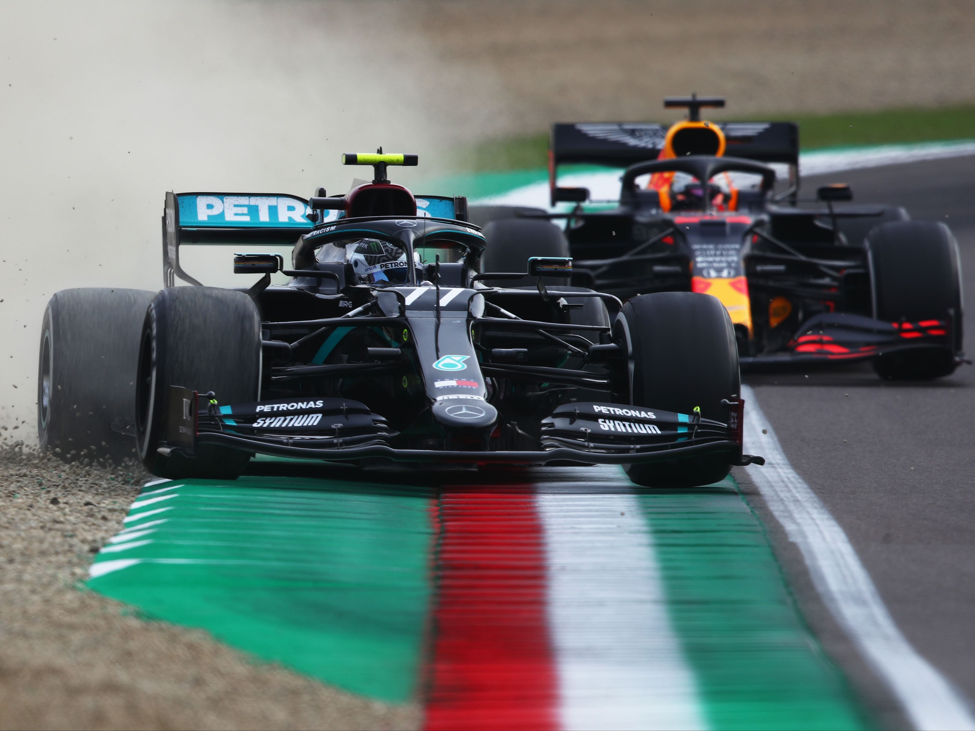 Valtteri Bottas (77) runs wide as he leads Max Verstappen (33) during the 2020 F1 Emilia Romagna Grand Prix. (Photo by Joe Portlock/Getty Images)