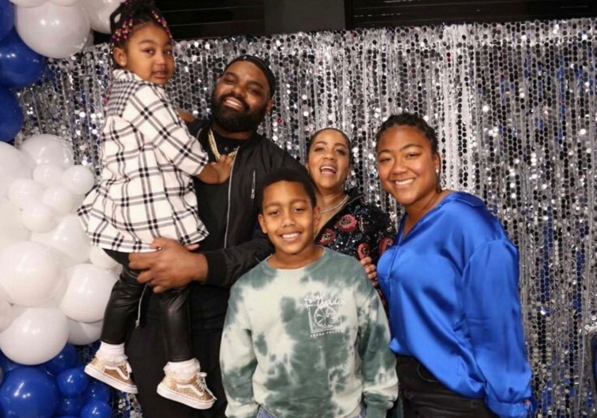 Michael Oher with his wife and kids