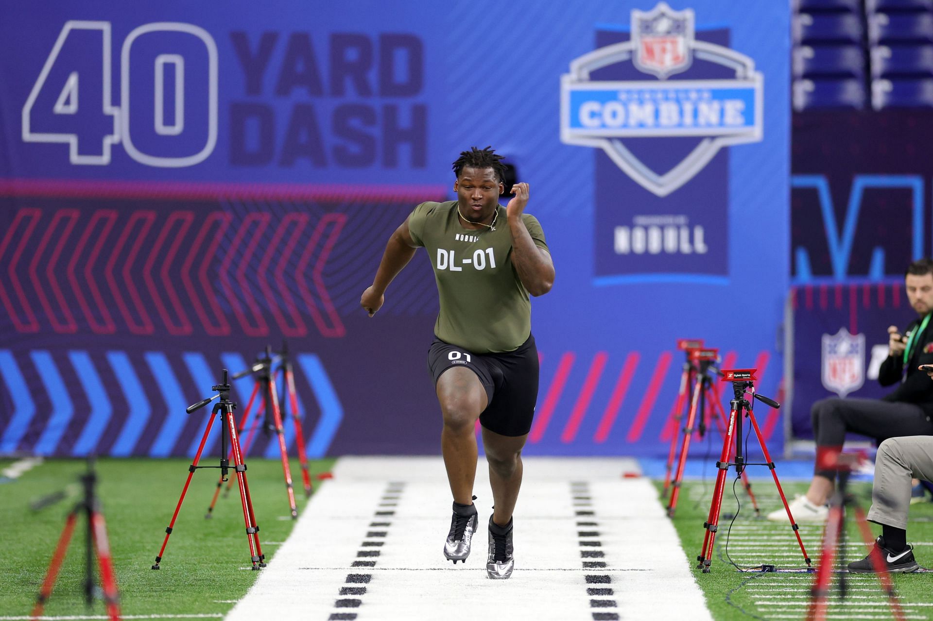 Keeanu Benton of Wisconsin participates in the 40-yard dash during the NFL Combine 