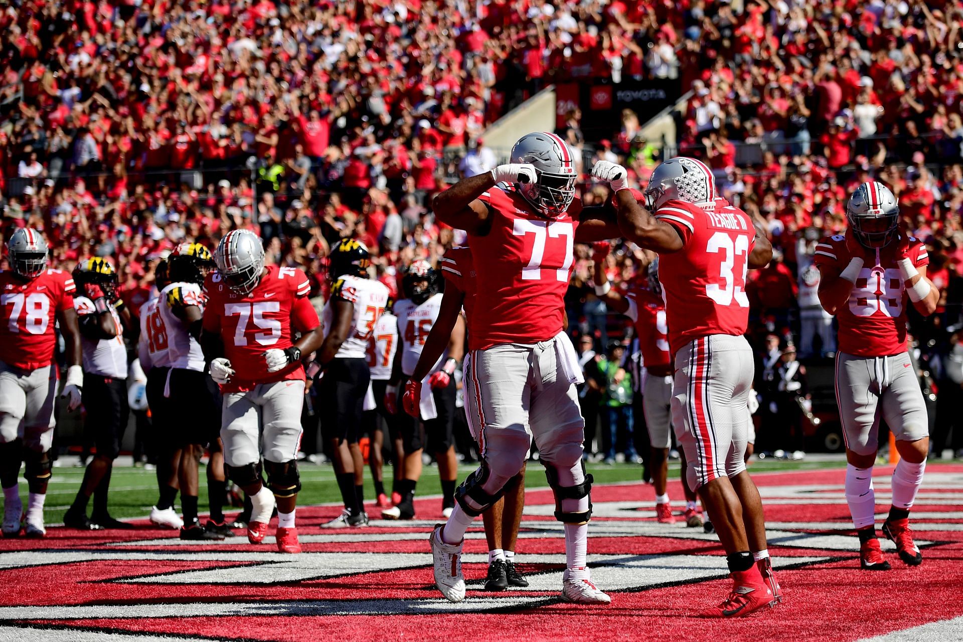 Master Teague III #33 of the Ohio State Buckeyes celebrates with Paris Johnson Jr. #77