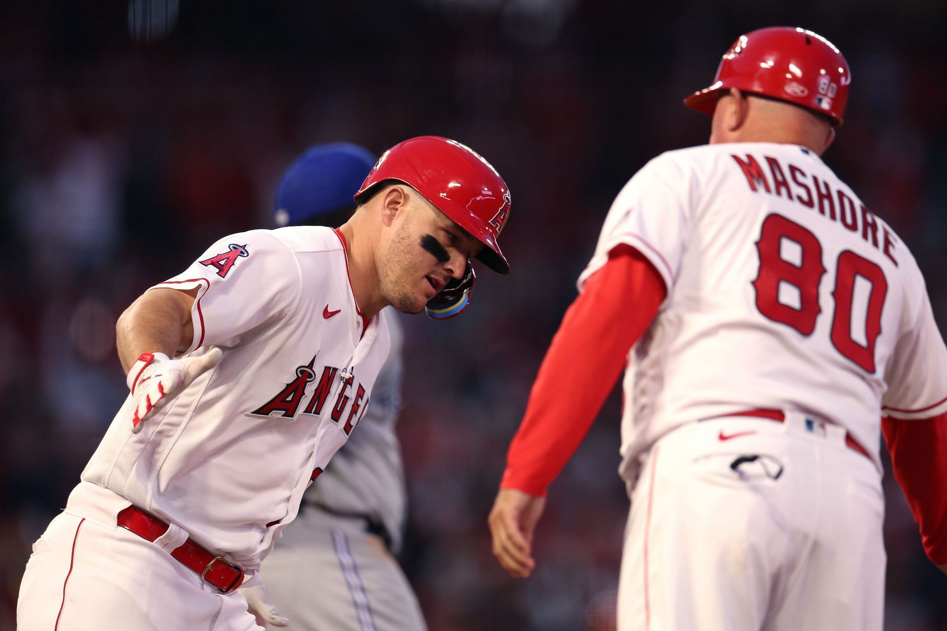 Mike Trout of the Los Angeles Angels celebrates his homerun with Damon Mashore at Angel Stadium of Anaheim
