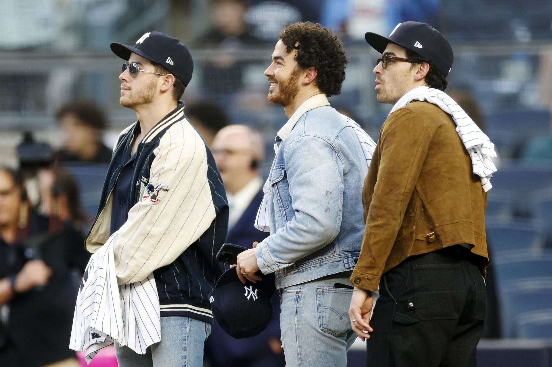 Nick Jonas, Kevin Jonas and Joe Jonas look on before the first inning between the New York Yankees and the Philadelphia Phillies at Yankee Stadium on April 04, 2023 in the Bronx borough of New York City.