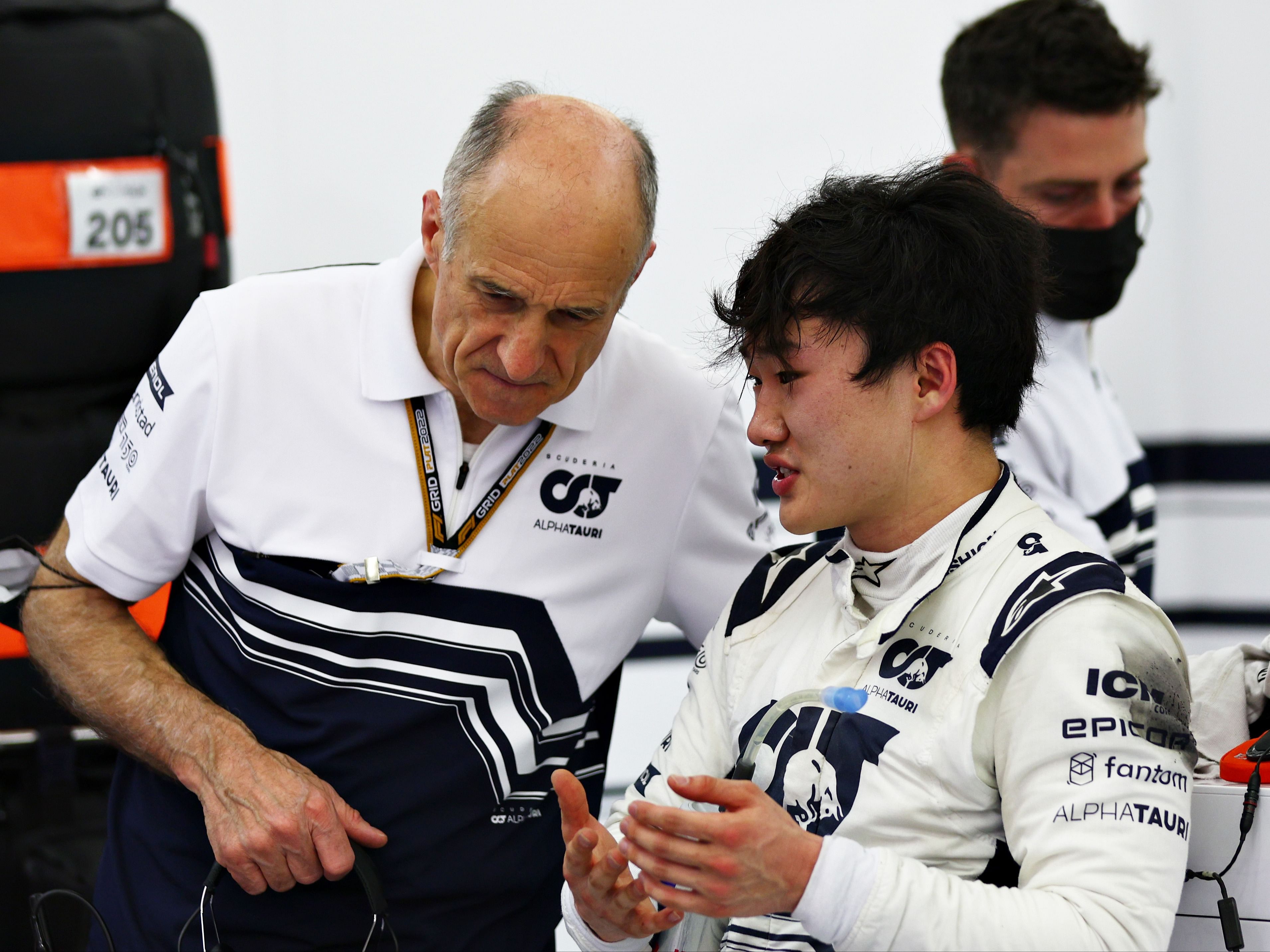 Yuki Tsunoda talks to Franz Tost in the garage during Day Two of 2022 F1 Testing at Bahrain International Circuit. (Photo by Lars Baron/Getty Images)