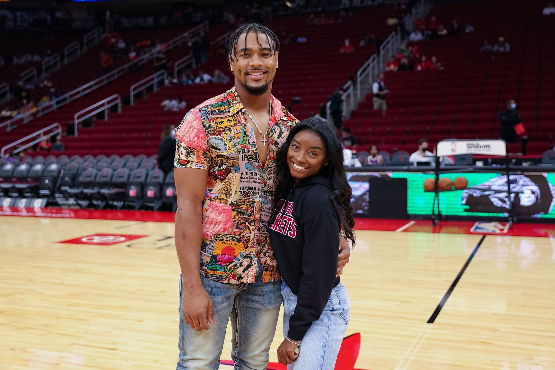 Simone Biles and Jonathan Owens attend a game between the Houston Rockets and the Los Angeles Lakers at Toyota Center on December 28, 2021 in Houston, Texas. NOTE TO USER: User expressly acknowledges and agrees that, by downloading and or using this photograph, User is consenting to the terms and conditions of the Getty Images License Agreement. (Photo by Carmen Mandato/Getty Images)