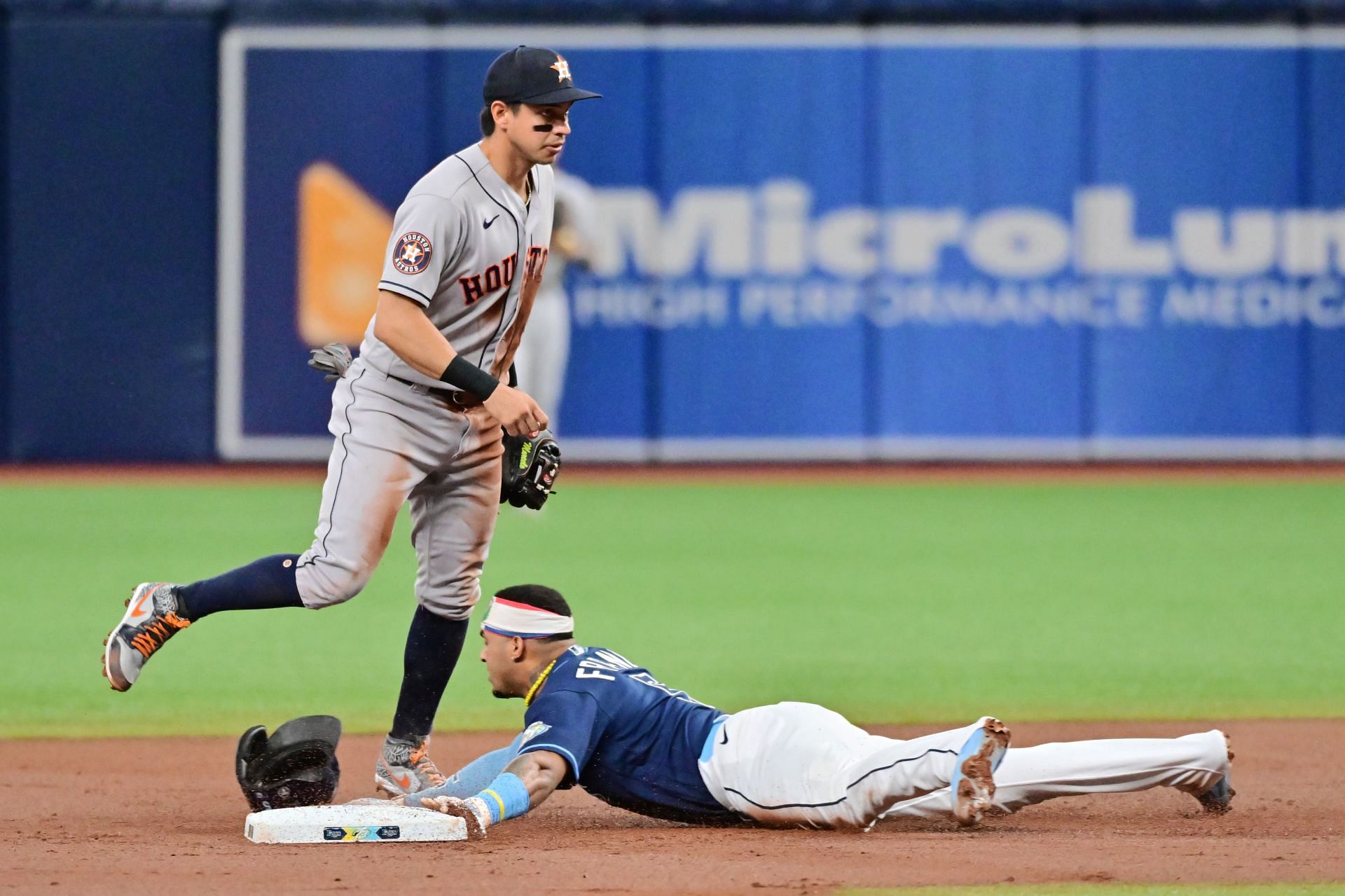 Wander Franco #5 of the Tampa Bay Rays steals second base from under Mauricio Dubon #14 of the Houston Astros