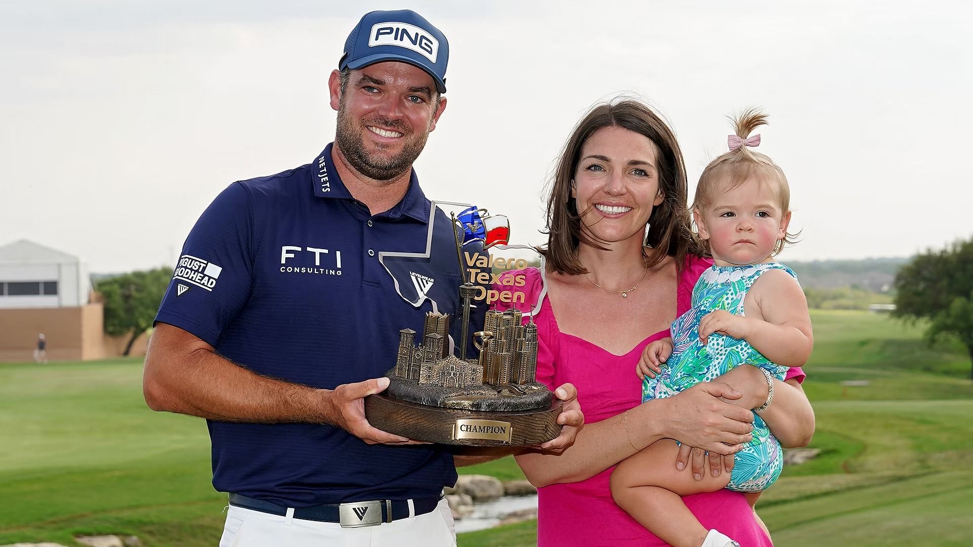 Corey Conners poses with his wife and daughter after Valero Texas Open victory