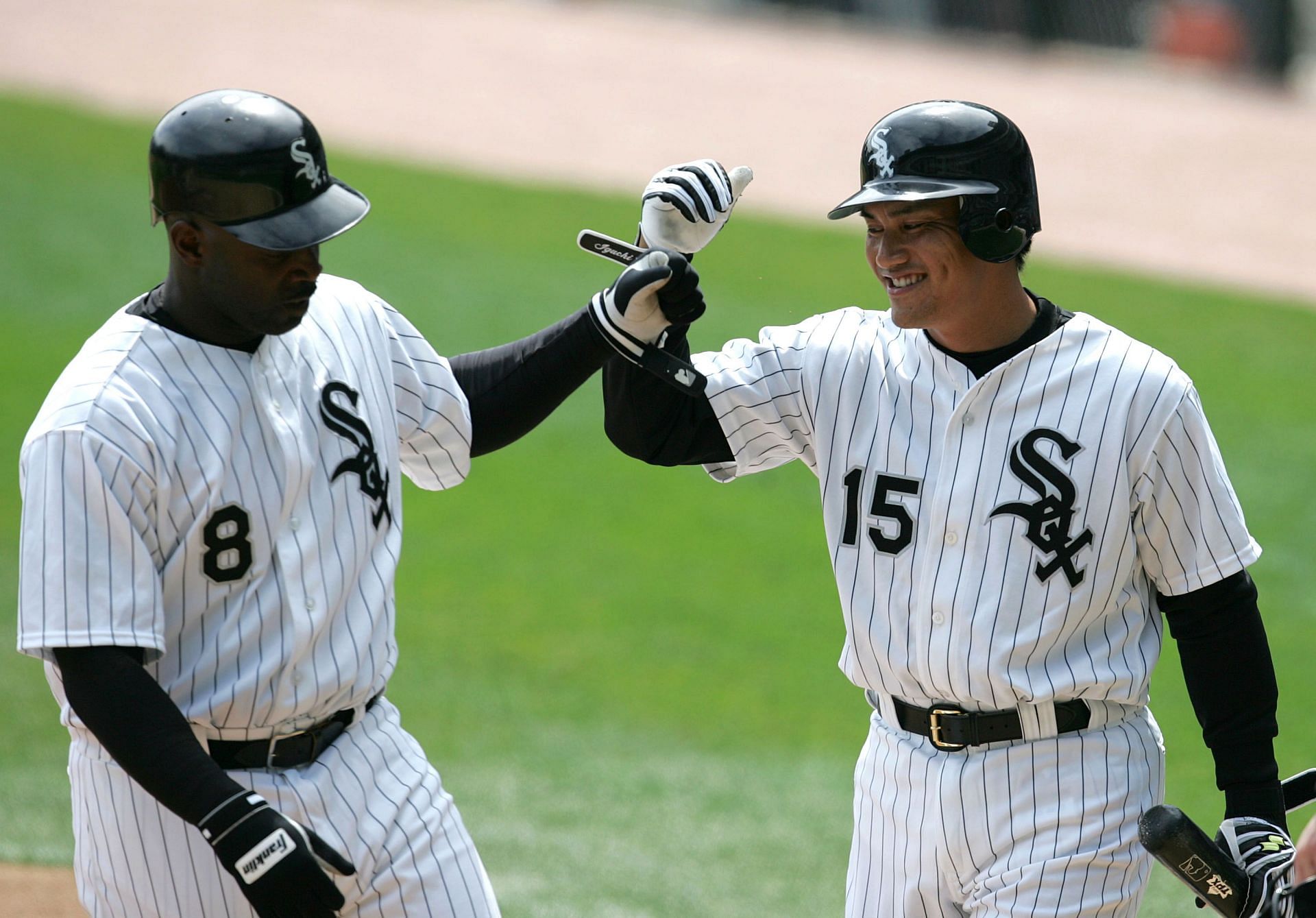 Cleveland Indians v Chicago White Sox: CHICAGO - APRIL 7: Tadahito Iguchi #15 of the Chicago White Sox congratulates teammate Carl Everett #8 after both players score in the first inning on a hit by teammate Paul Konerko against the Cleveland Indians on April 7, 2005 at U.S. Cellular Field in Chicago, Illinois. The Indians defeated the White Sox 11-5 in 11 innings. (Photo by Jonathan Daniel/Getty Images)