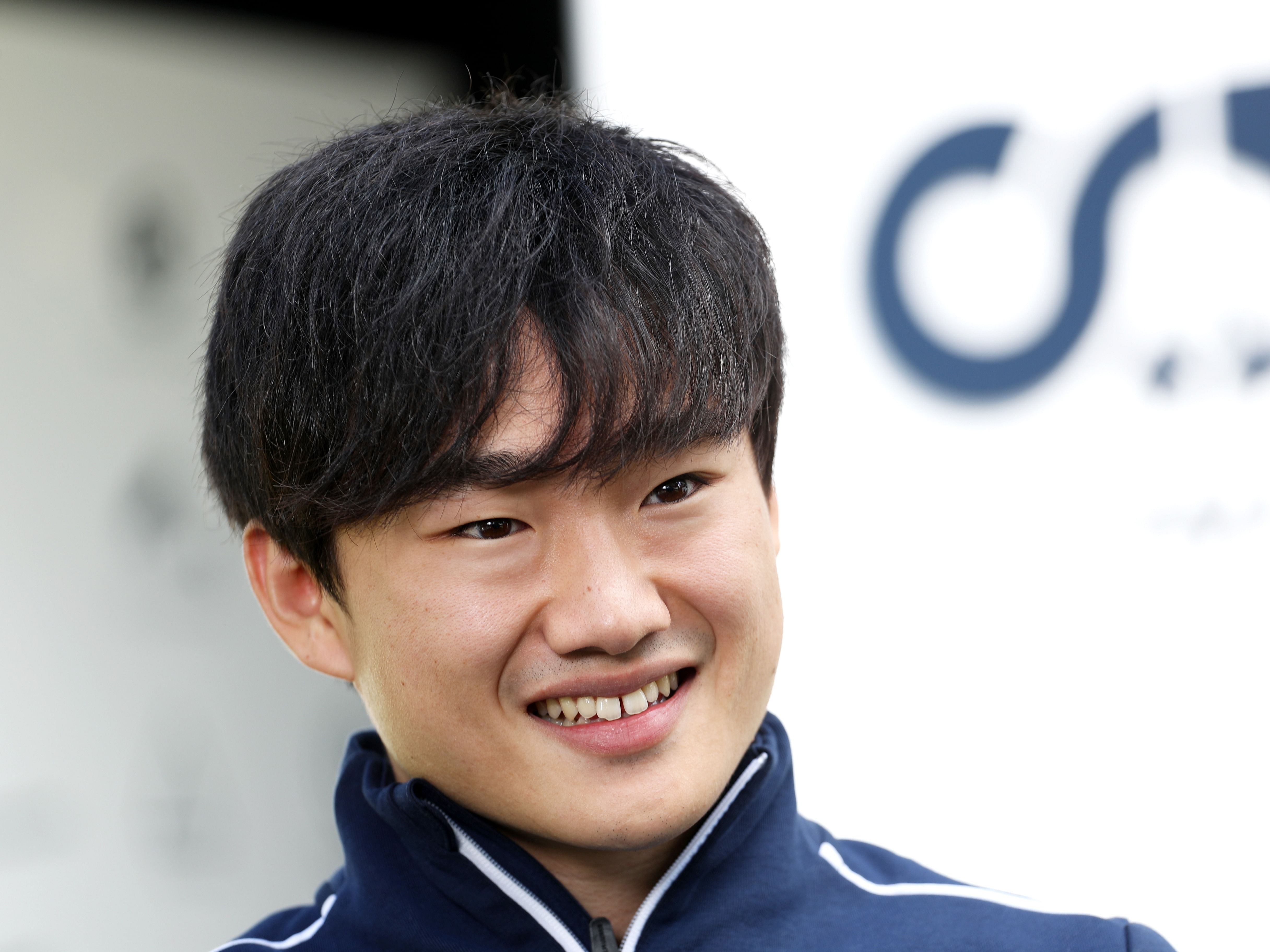 Yuki Tsunoda talks to the media in the paddock during previews ahead of the 2023 F1 Australian Grand Prix. (Photo by Peter Fox/Getty Images)