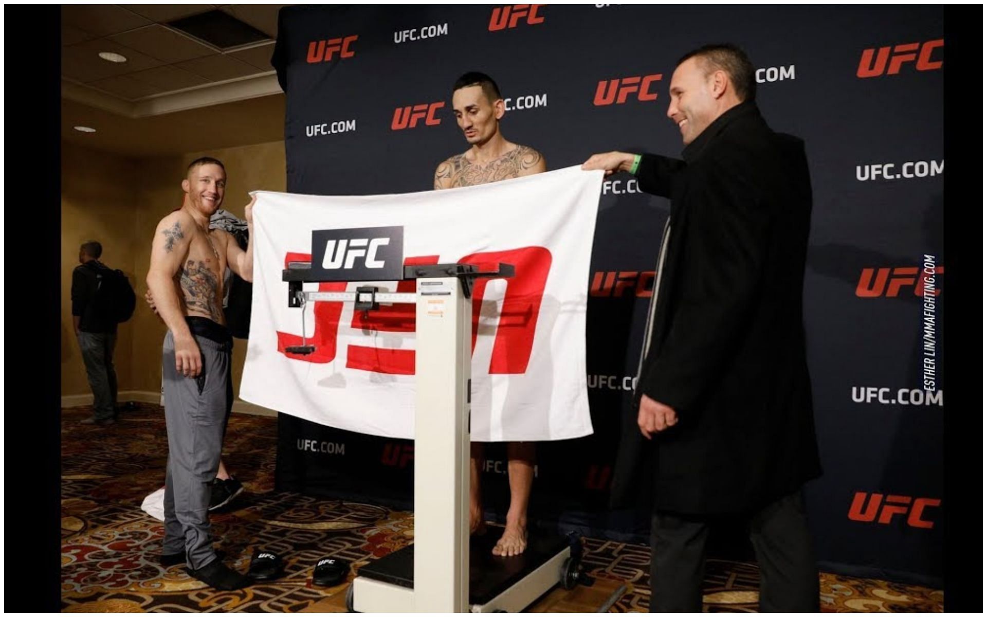 Justin Gaethje holdimg the towel for Max Holloway at UFC 218 weigh-ins