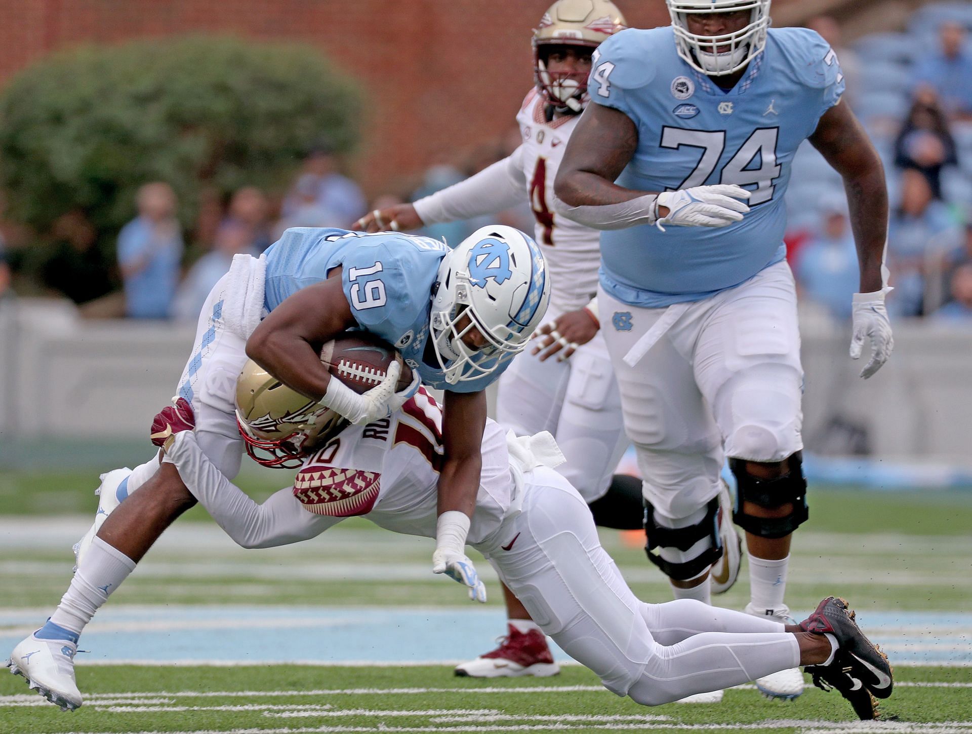 Jammie Robinson #10 of the Florida State Seminoles tackles Ty Chandler #19 of the North Carolina Tar Heels