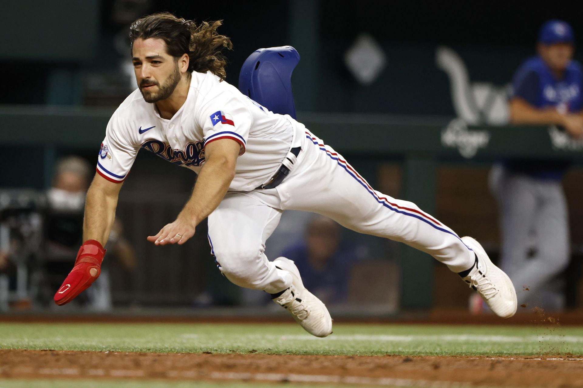 Josh Smith of the Texas Rangers dives for home plate to score a run.