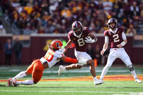 Ky Thomas #8 of the Minnesota Golden Gophers is tackled by Sydney Brown