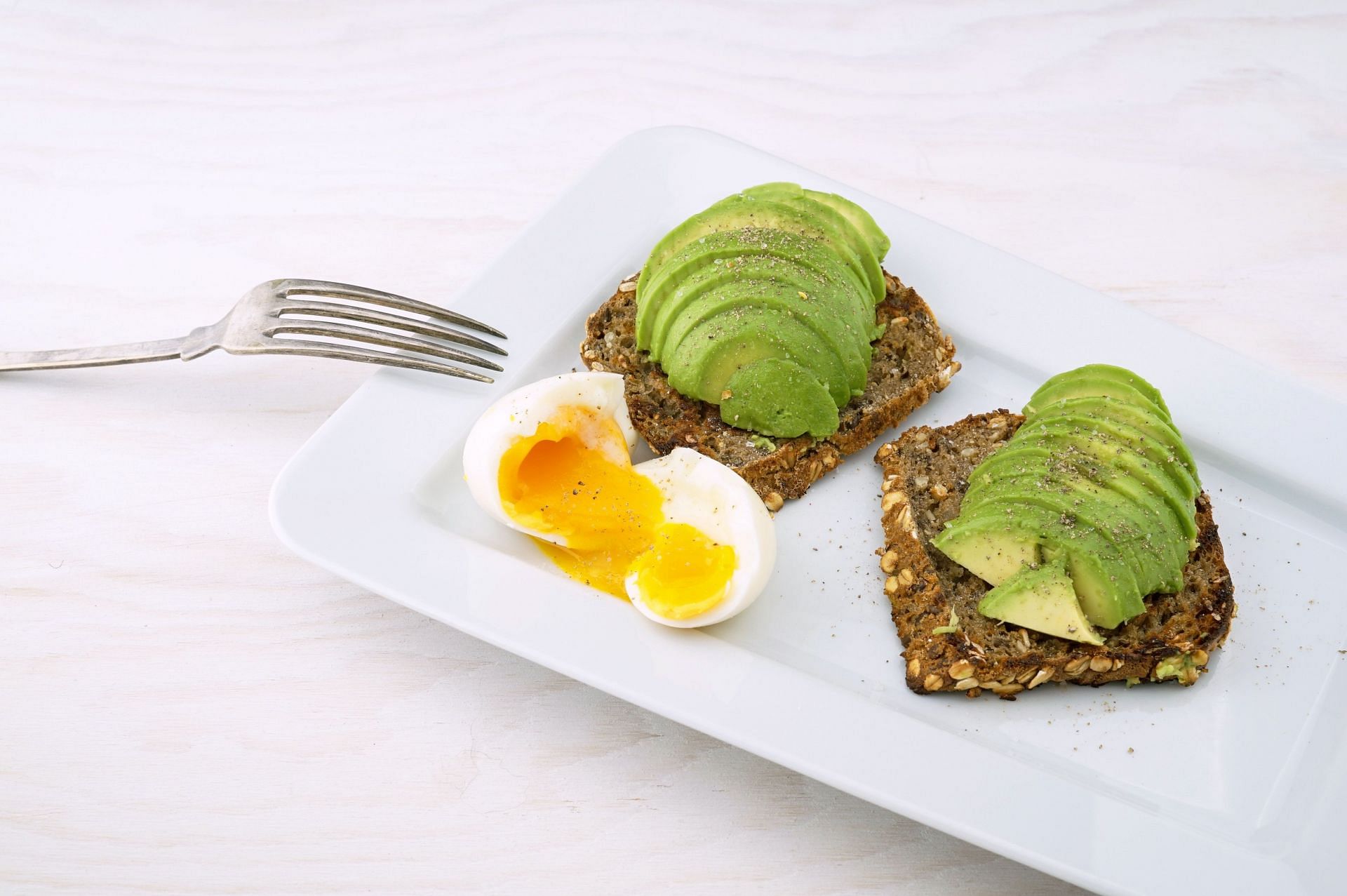 Eggs and avocado are great sources of Vitamin E. (Image via Unsplash/ Wesual Click)