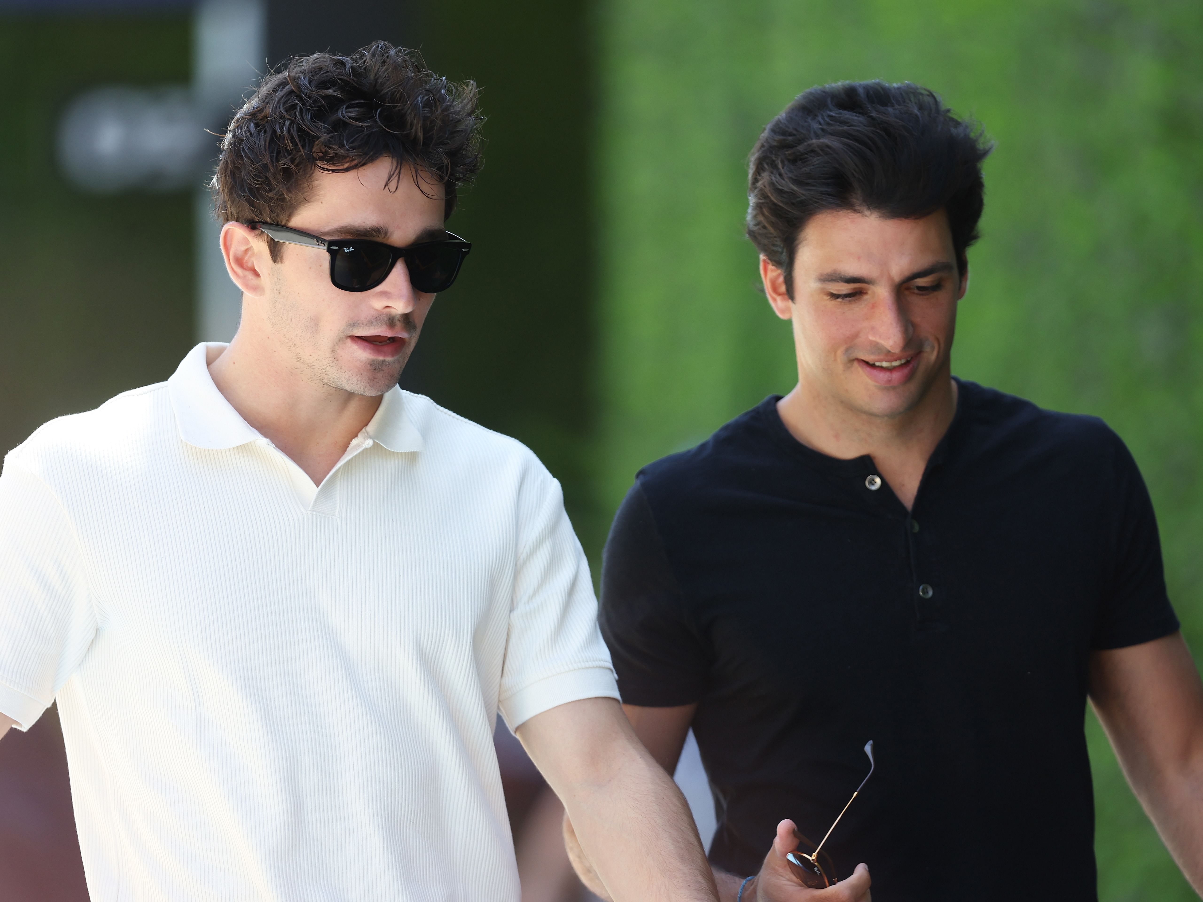 Charles Leclerc and Carlos Sainz walk in the paddock during previews ahead of the 2023 F1 Saudi Arabian Grand Prix (Photo by Lars Baron/Getty Images)