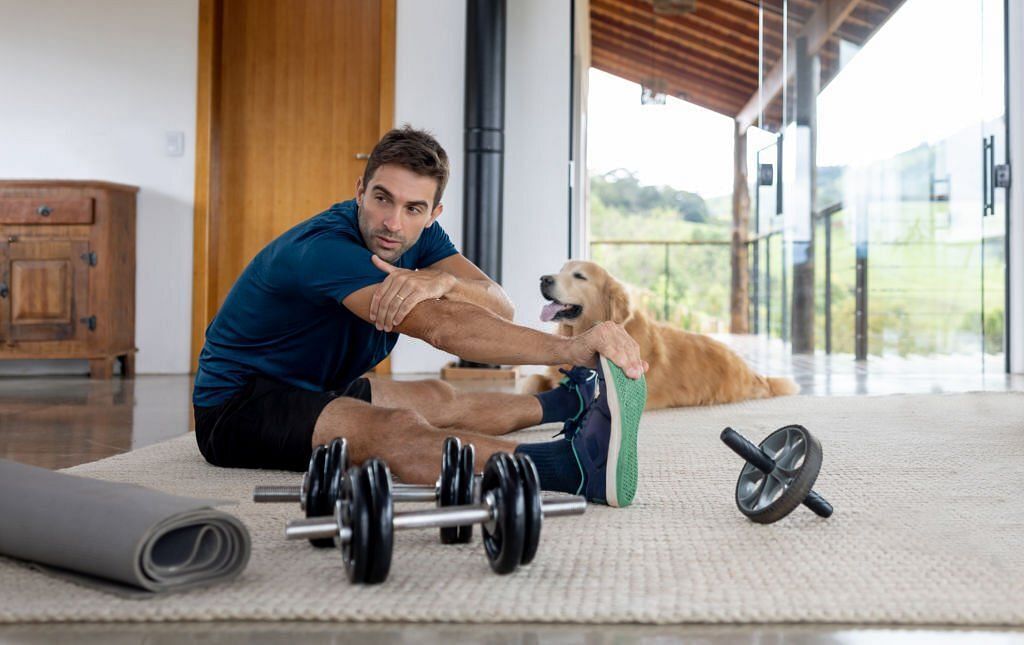Stretching at home (Image via Getty Images)