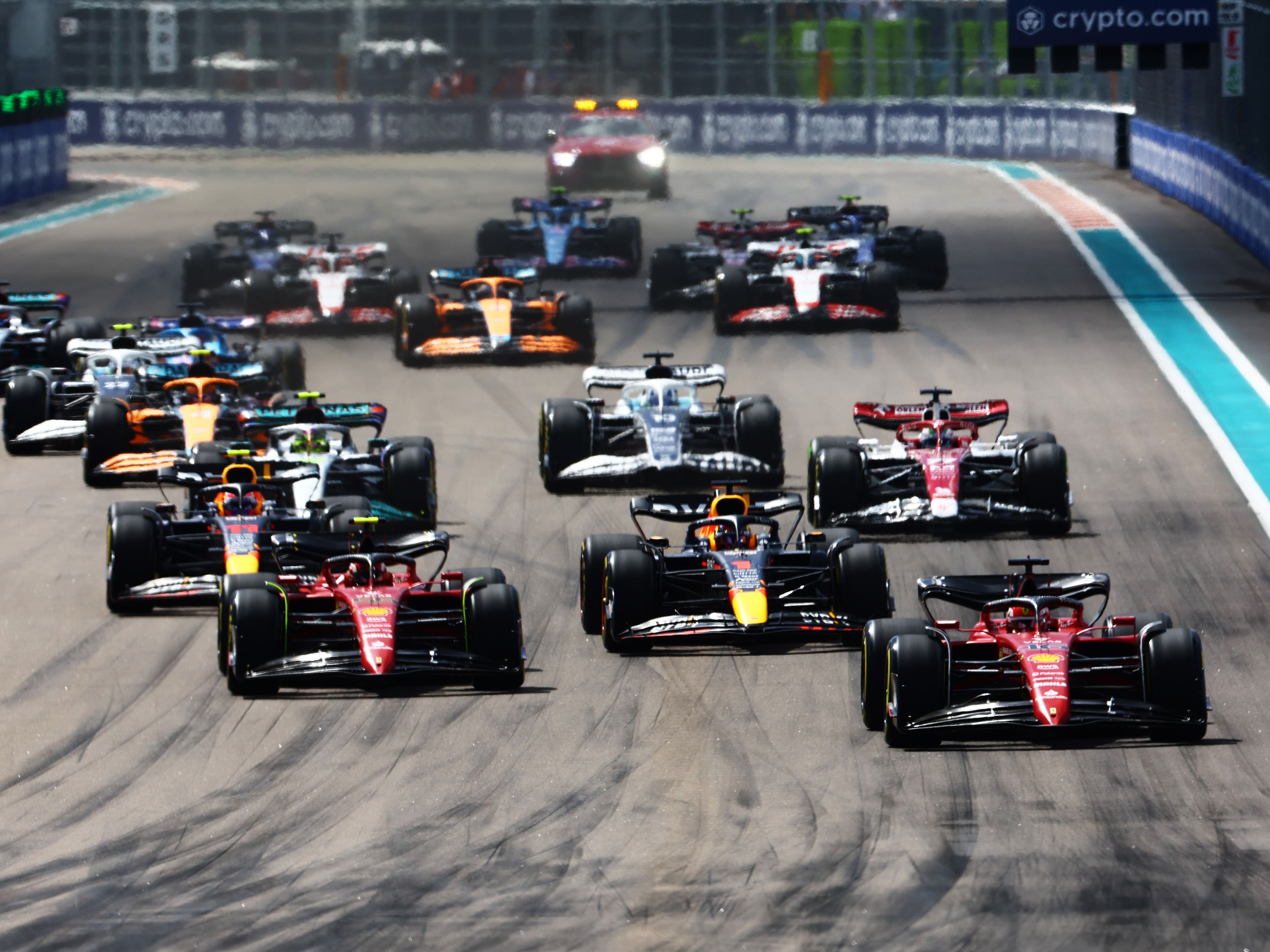 Charles Leclerc (16) leads Max Verstappen (1), Carlos Sainz (55) and the rest of the field into turn one at the start during the 2022 F1 Miami Grand Prix. (Photo by Mark Thompson/Getty Images)