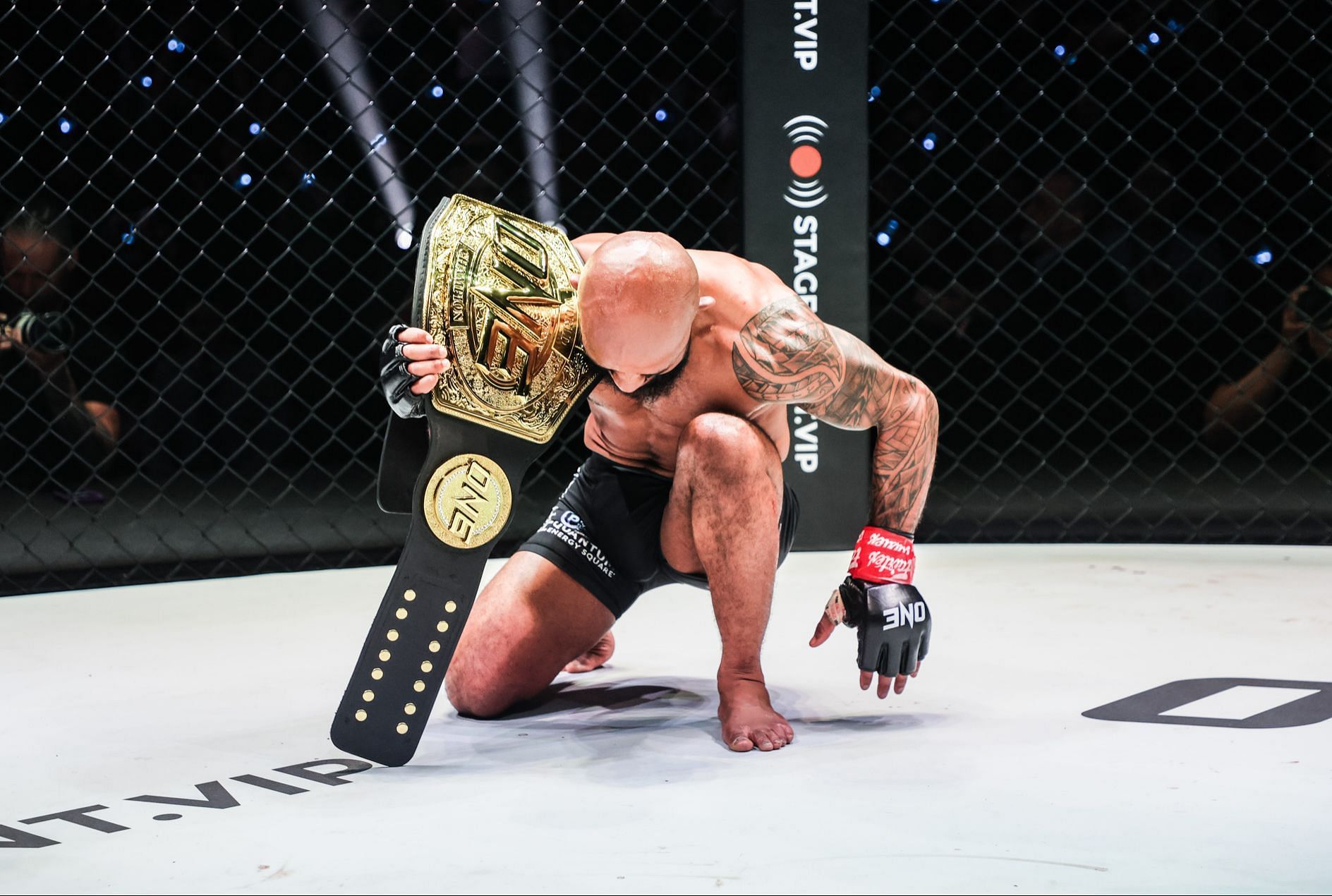 Demetrious Johnson poses with 26 pounds of solid gold after retaining his ONE flyweight word title