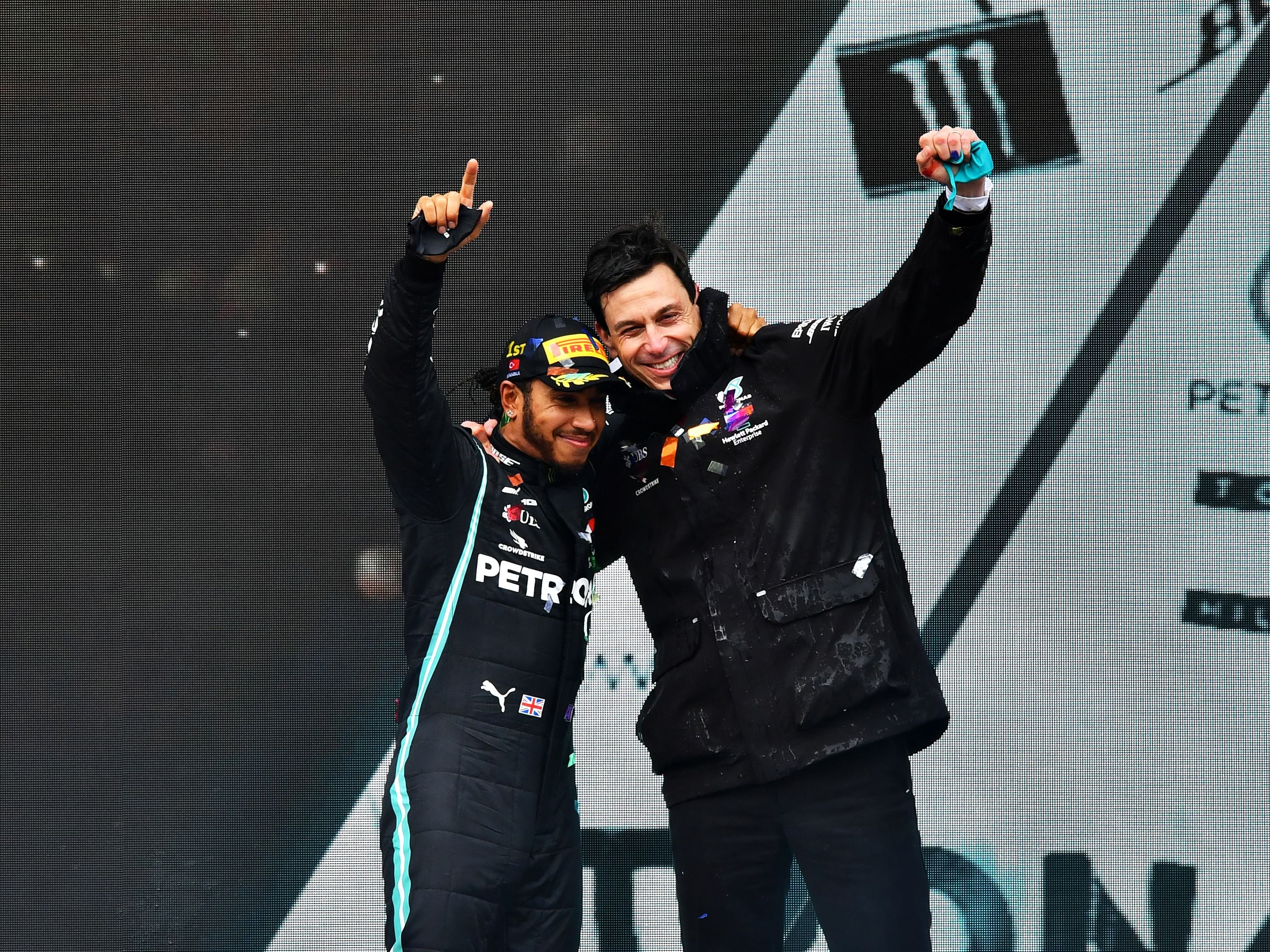 Lewis Hamilton celebrates winning the 7th F1 World Drivers Championship with Toto Wolff on the podium during the 2020 F1 Turkish Grand Prix. (Photo by Getty Images/Getty Images)