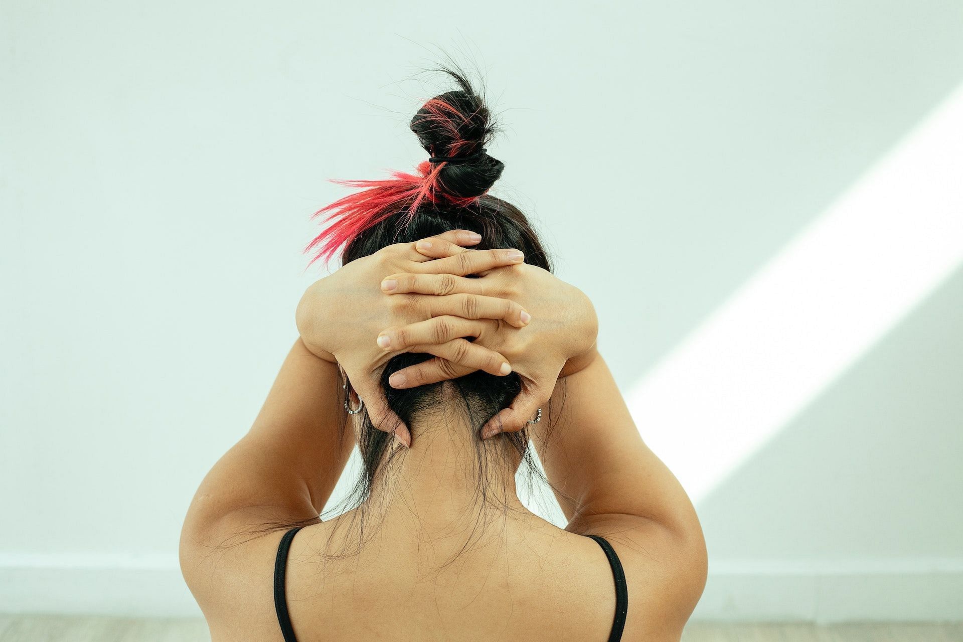 The chin tuck exercise eases neck pain and stiffness. (Photo via Pexels/Miriam Alonso)