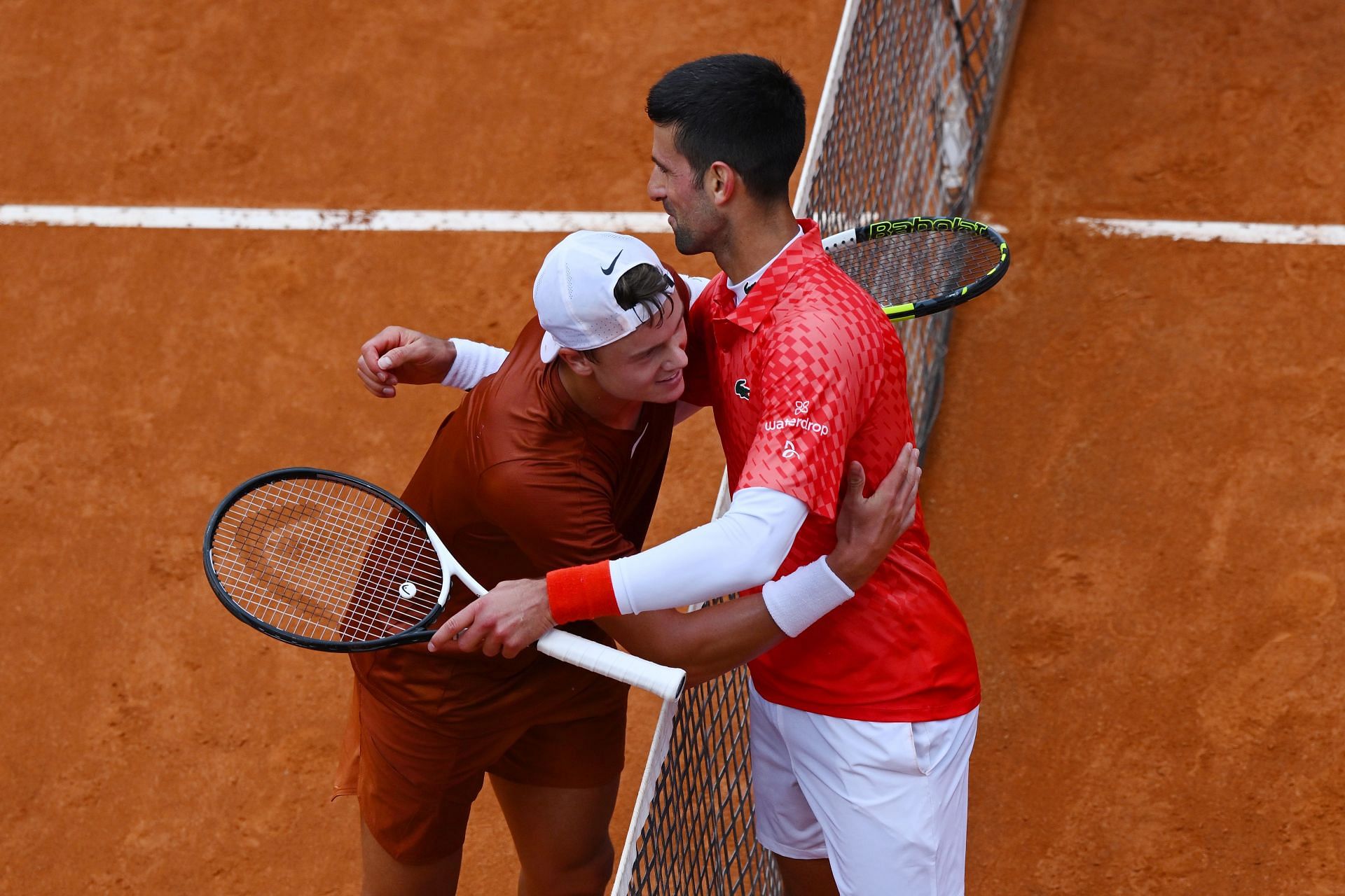 Novak Djokovic(right) congratulates Holger Rune(left) after their quarterfinal match at 2023 Italian Open