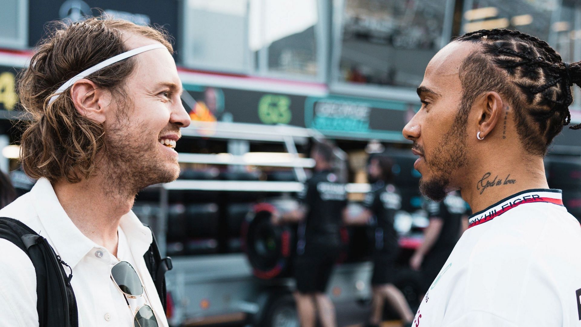 Former F1 driver Sebastian Vettel (L) and Lewis Hamilton (R) talk in the paddock prior to the 2023 F1 Monaco Grand Prix (Image via Twitter/@F1)
