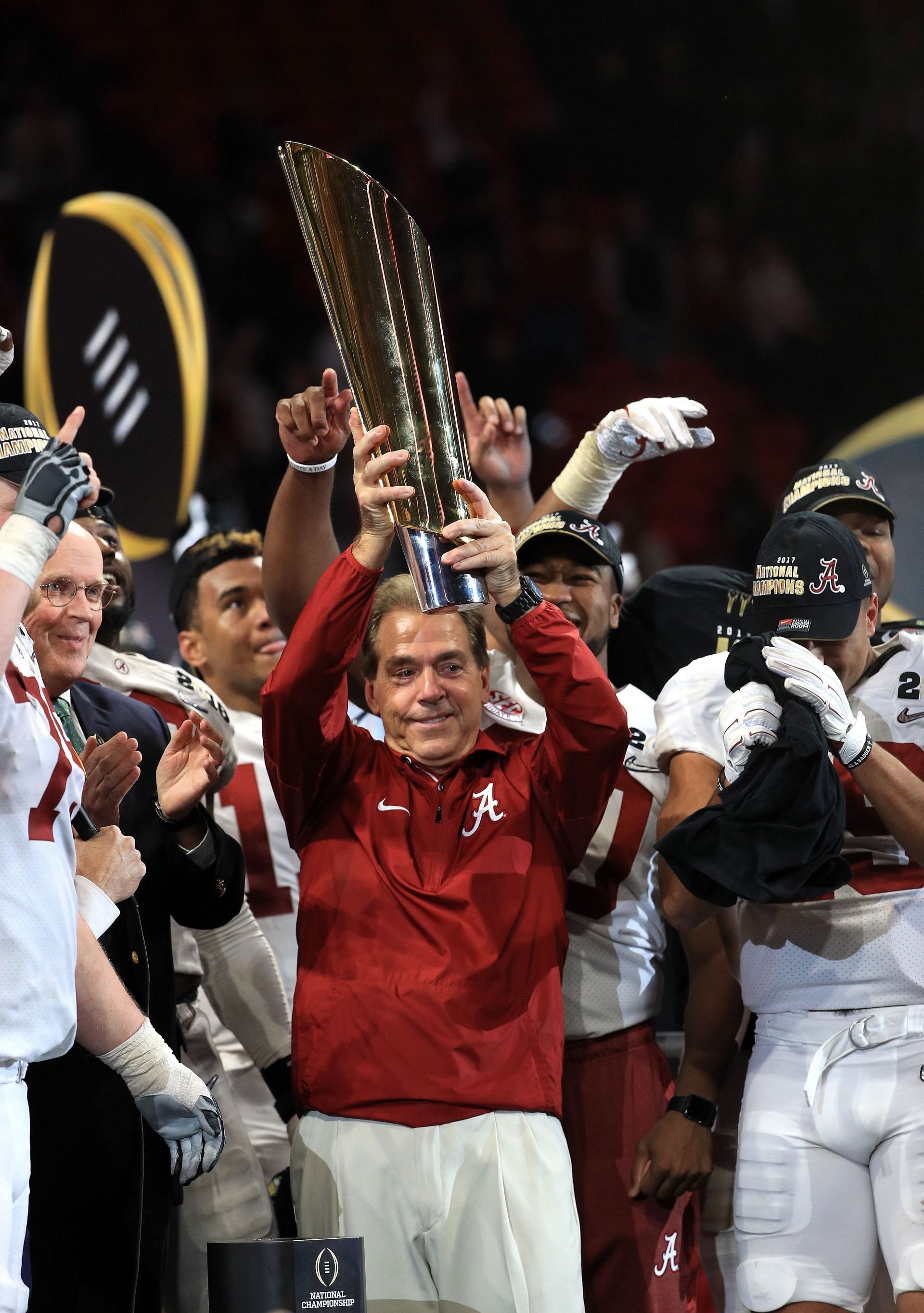 Nick Saban holds the championship trophy after beating Kirby Smart&#039;s Georgia Bulldogs.