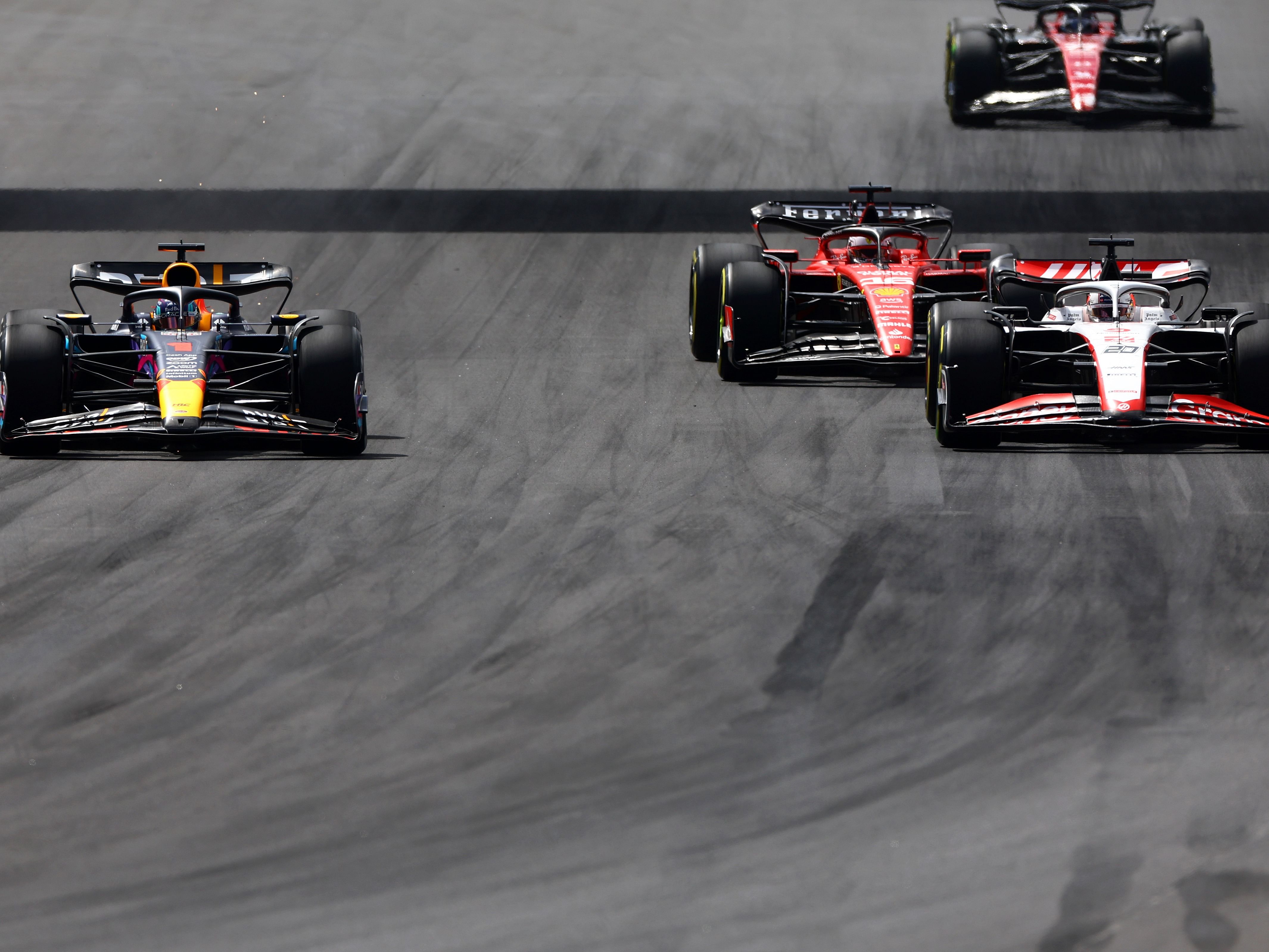 Max Verstappen (1) overtakes Kevin Magnussen (20) and Charles Leclerc (16) during the 2023 F1 Miami Grand Prix. (Photo by Mark Thompson/Getty Images)