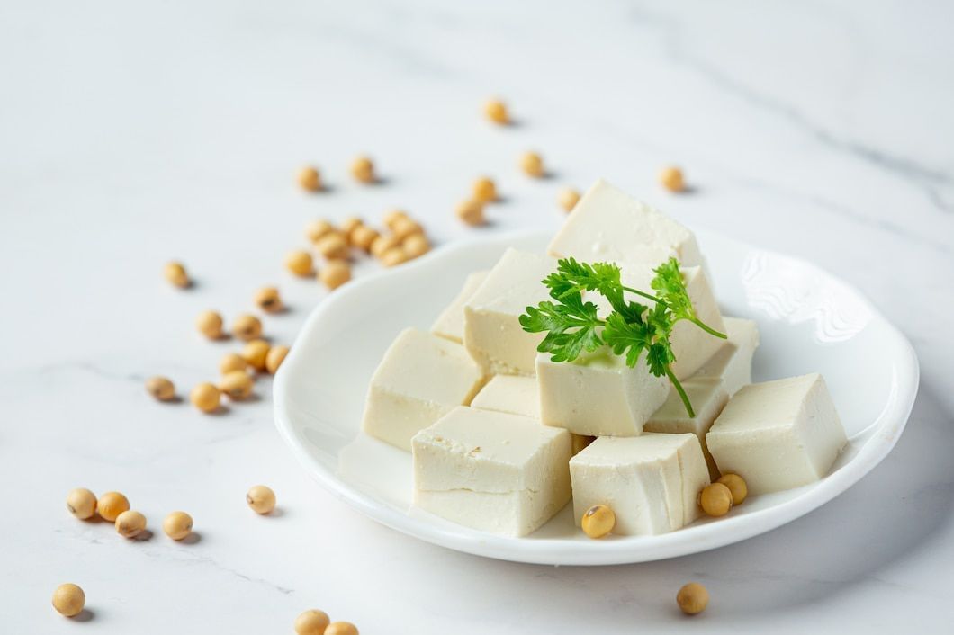 Plant-based proteins like tofu and nuts are key for vegans. (Image via Freepik/Jcomp)