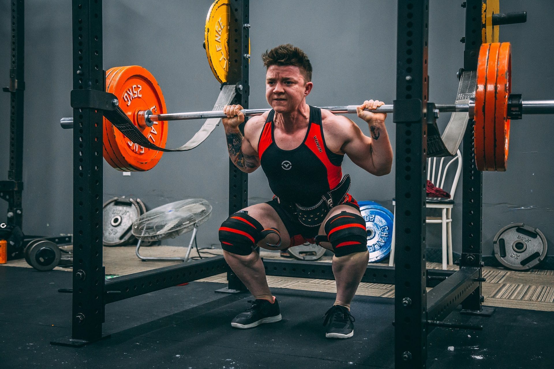Barbell squats (Photo by Alora Griffiths on Unsplash)