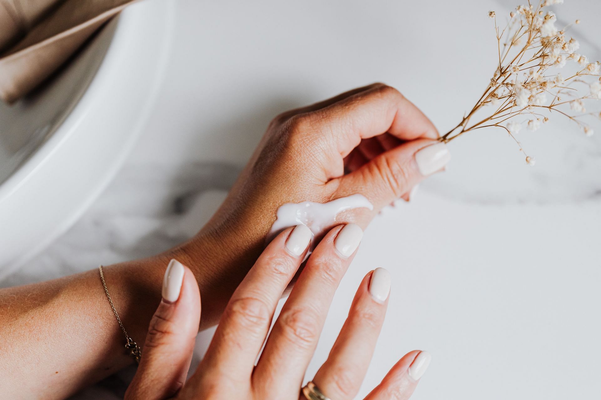 Moisturizing is one of the ways to get rid of cracked hands and feet (Image via Pexels)